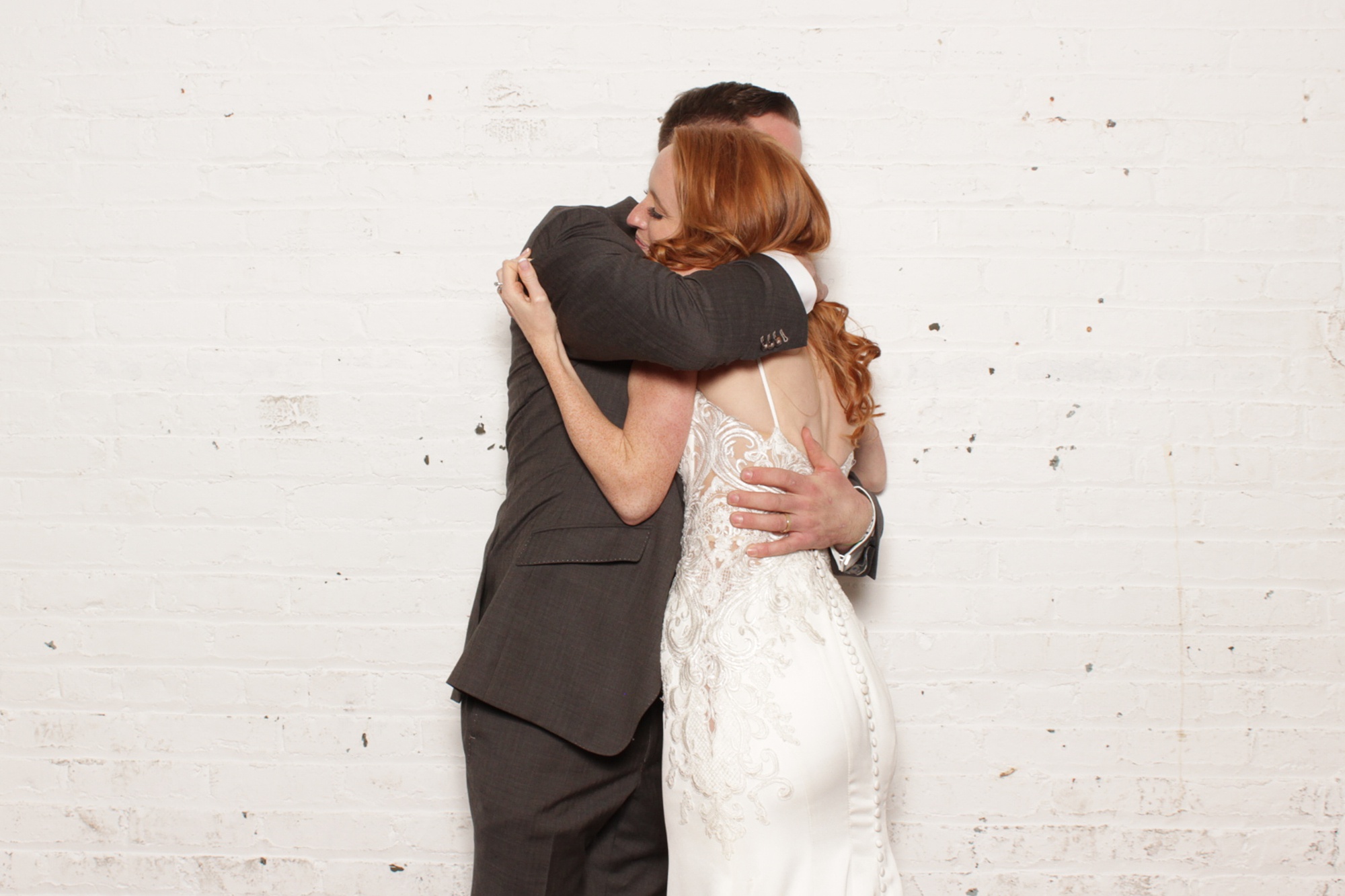 bride and groom hug during New Jersey reception photo booth