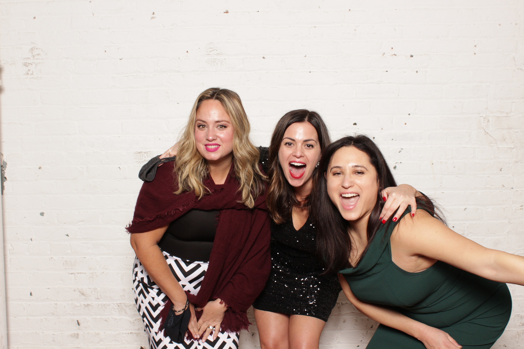 three women pose together during NJ wedding reception