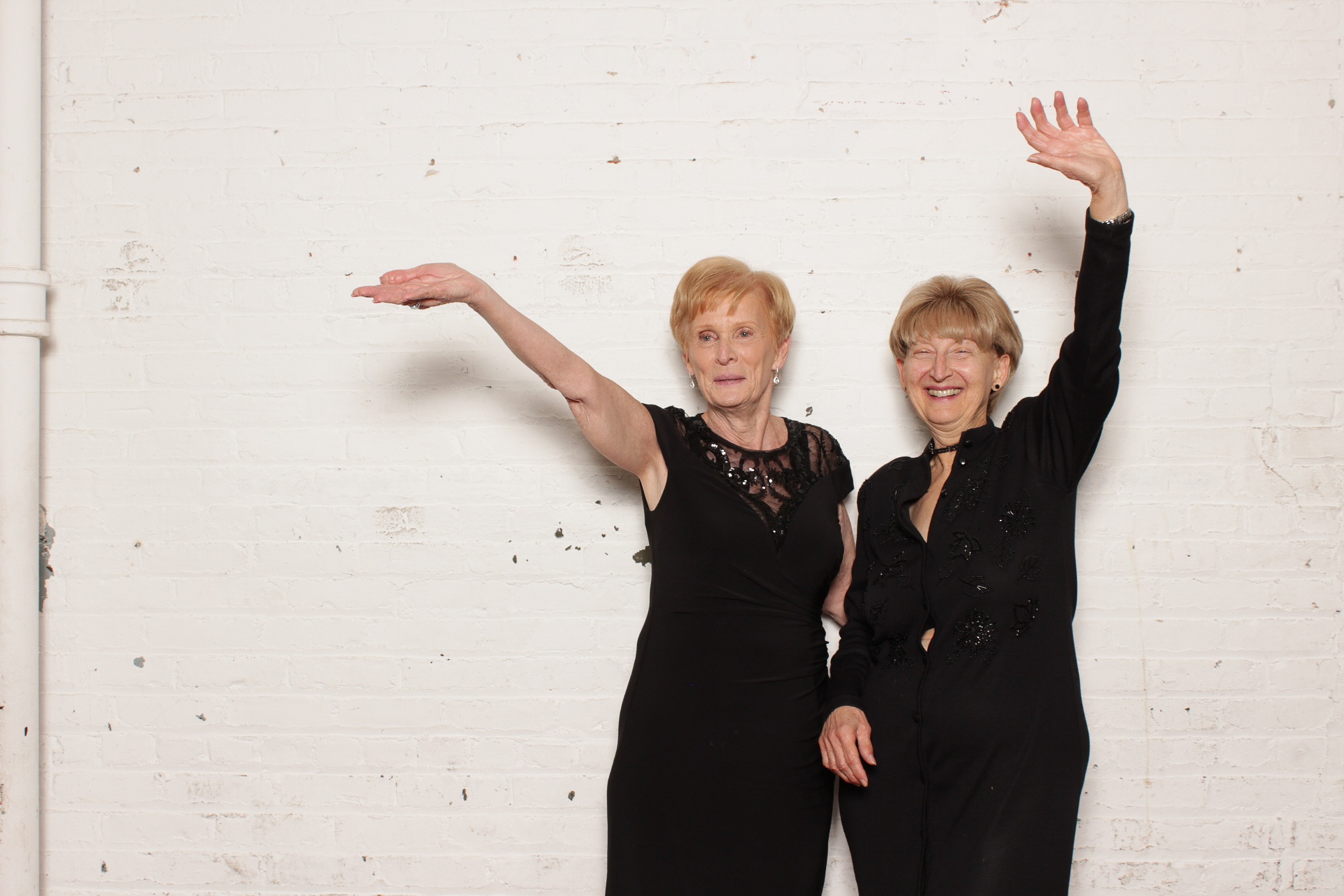 women wave during photo booth fun in New Jersey