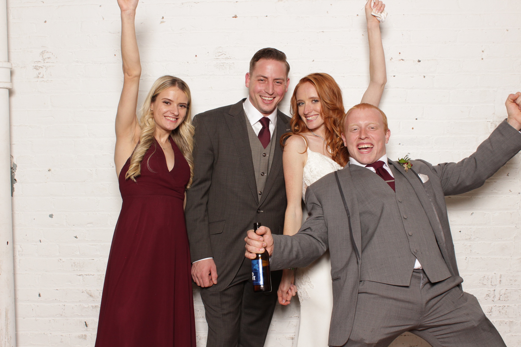 bride and groom laugh with guests in Art Factory Studios Photo Booth