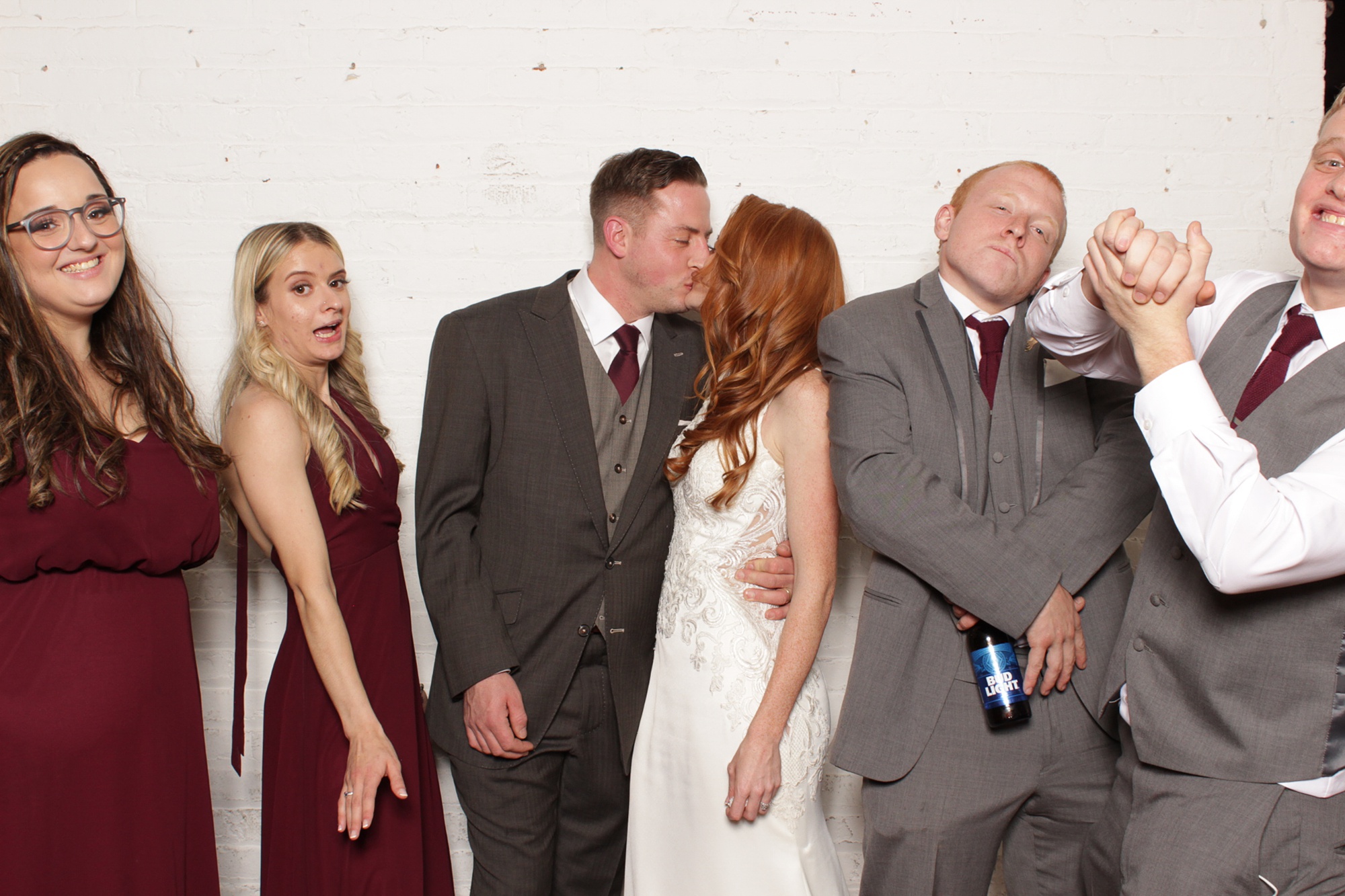 newlyweds kiss during photo booth