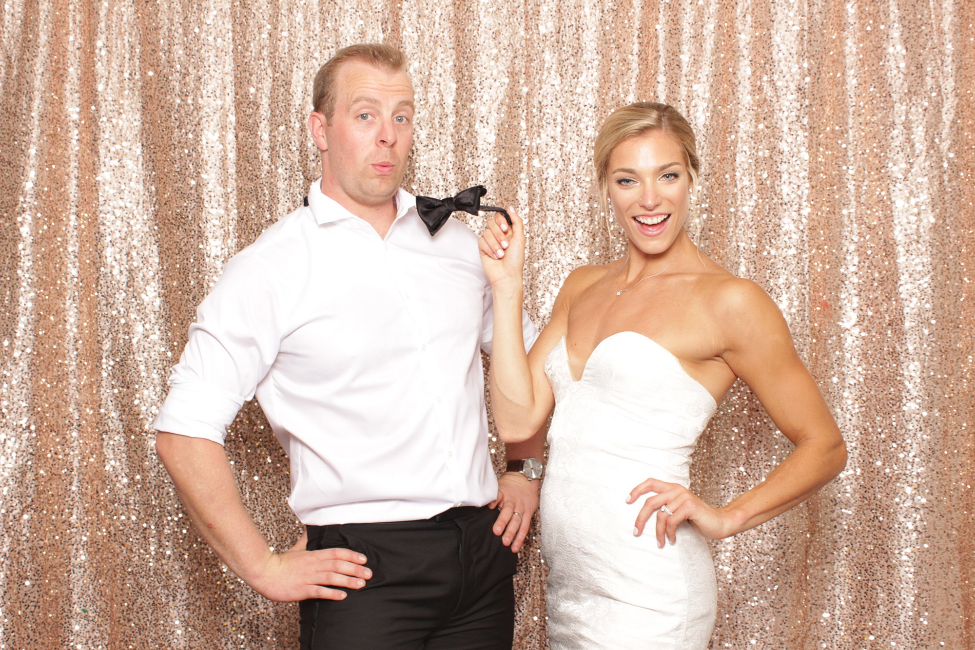 bride and groom pose in photo booth during LBI wedding reception