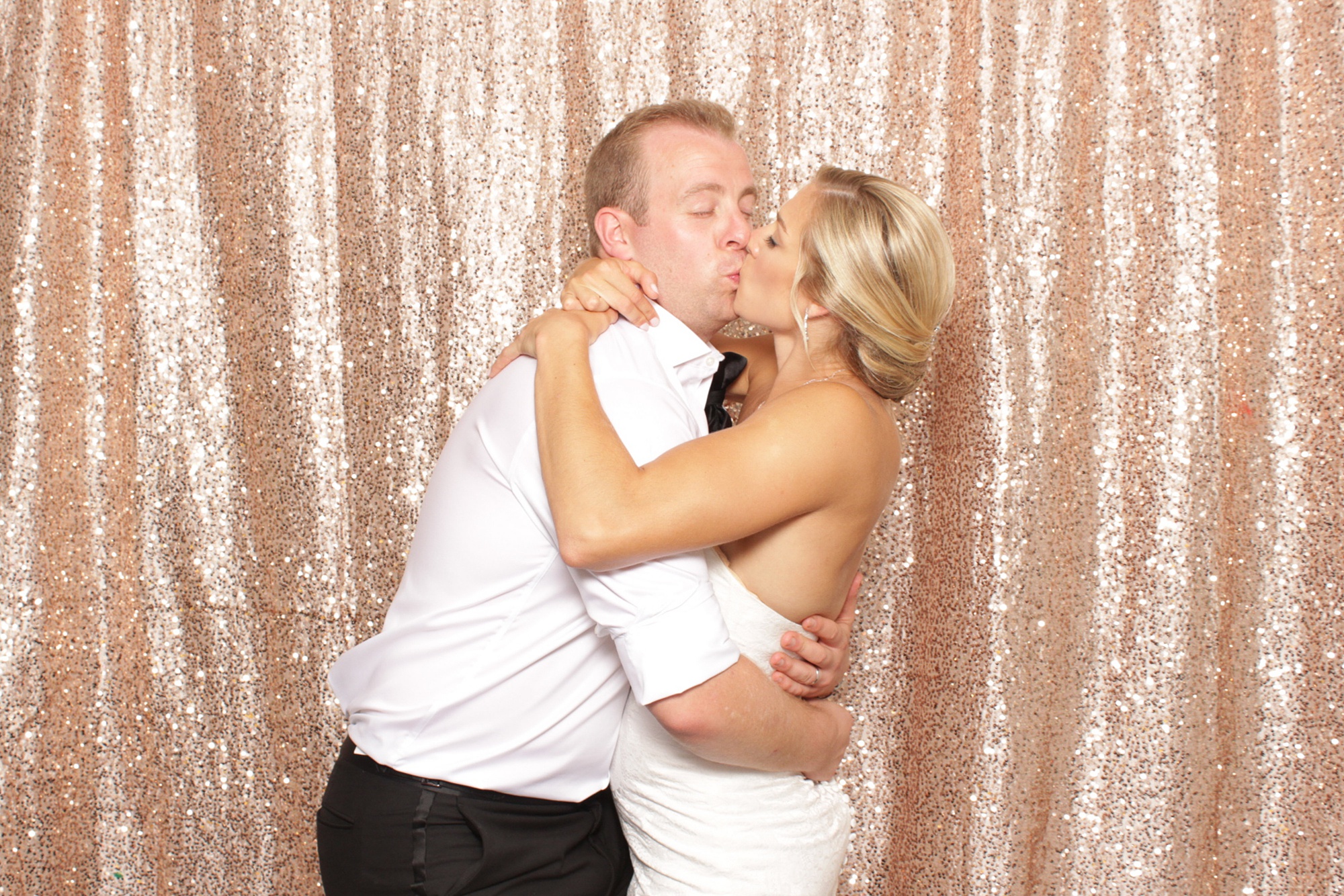 newlyweds kiss in photo booth at Brant Beach Yacht Club