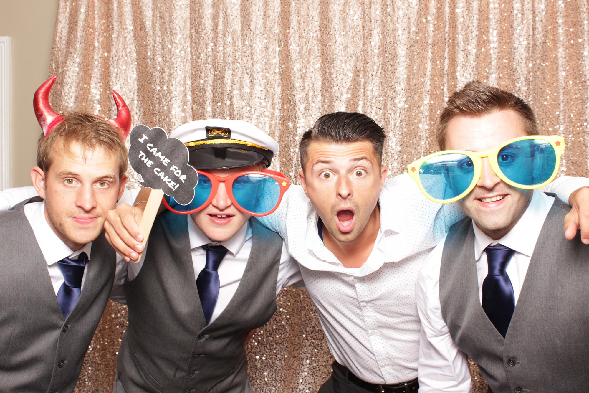 guests pose with big sunglasses during NJ wedding reception photo booth