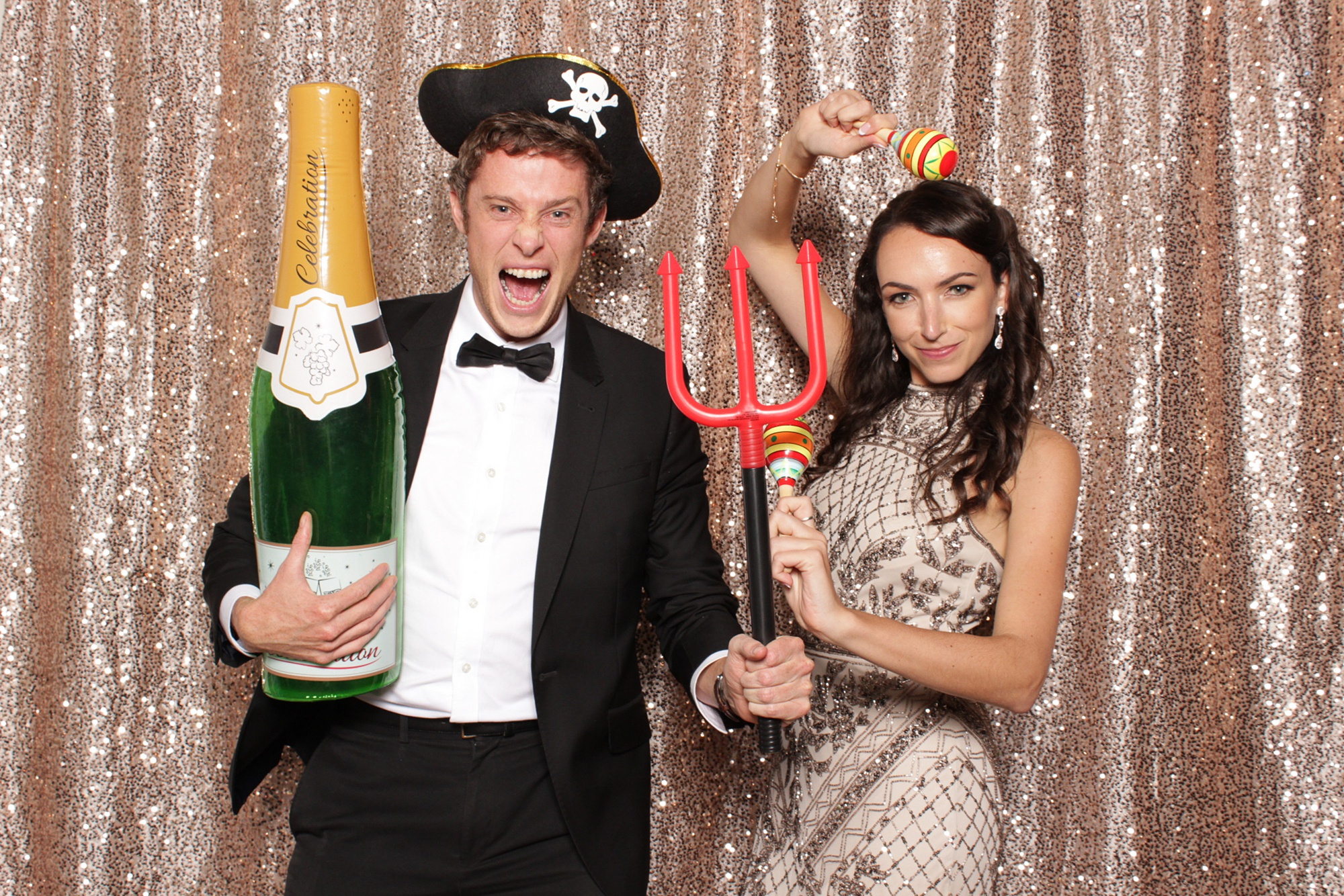 groomsman poses with bridesmaid in NJ photo booth