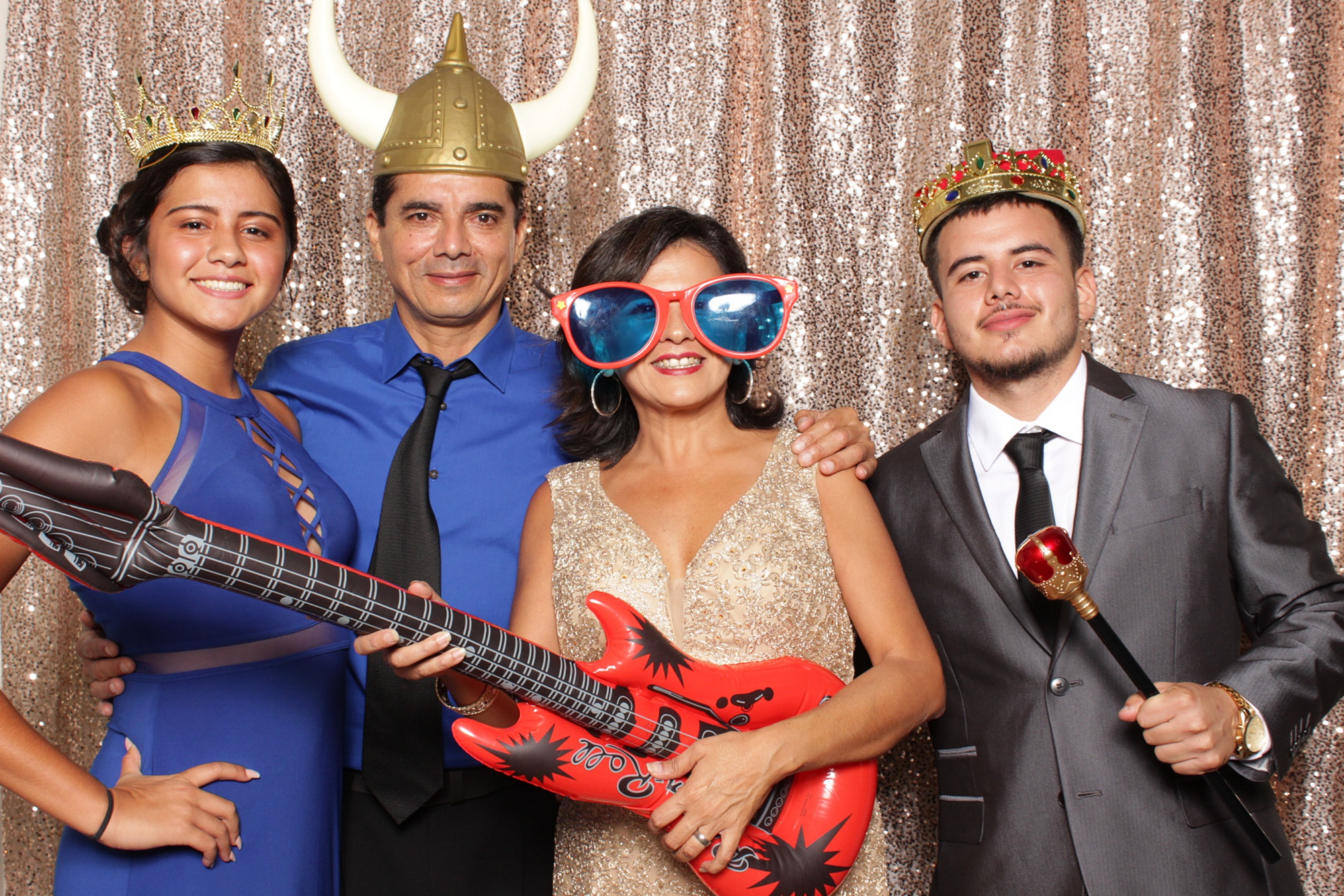 guests pose with fun props in Idalia Photography's photo booth