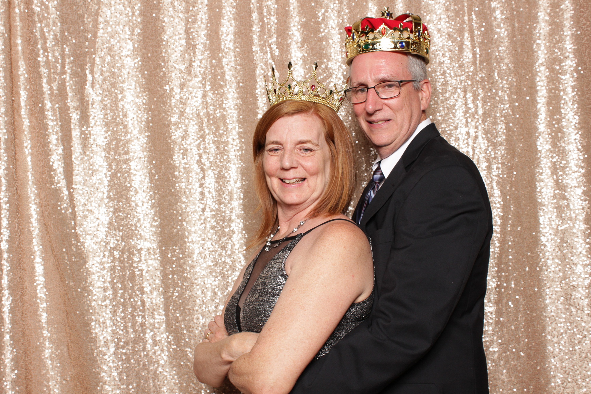 guest pose in photo booth with crowns
