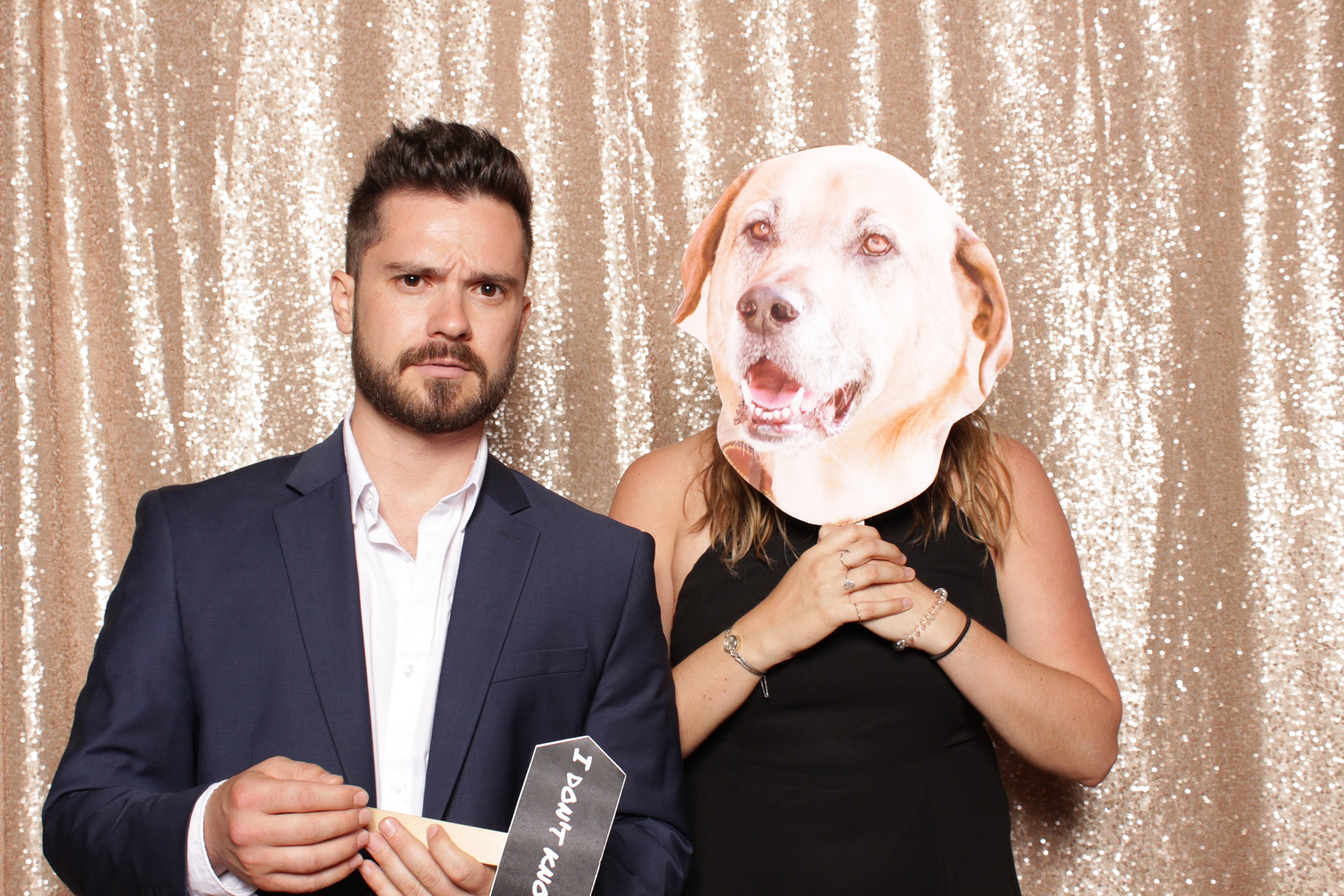 wedding guests pose with cutout of dog
