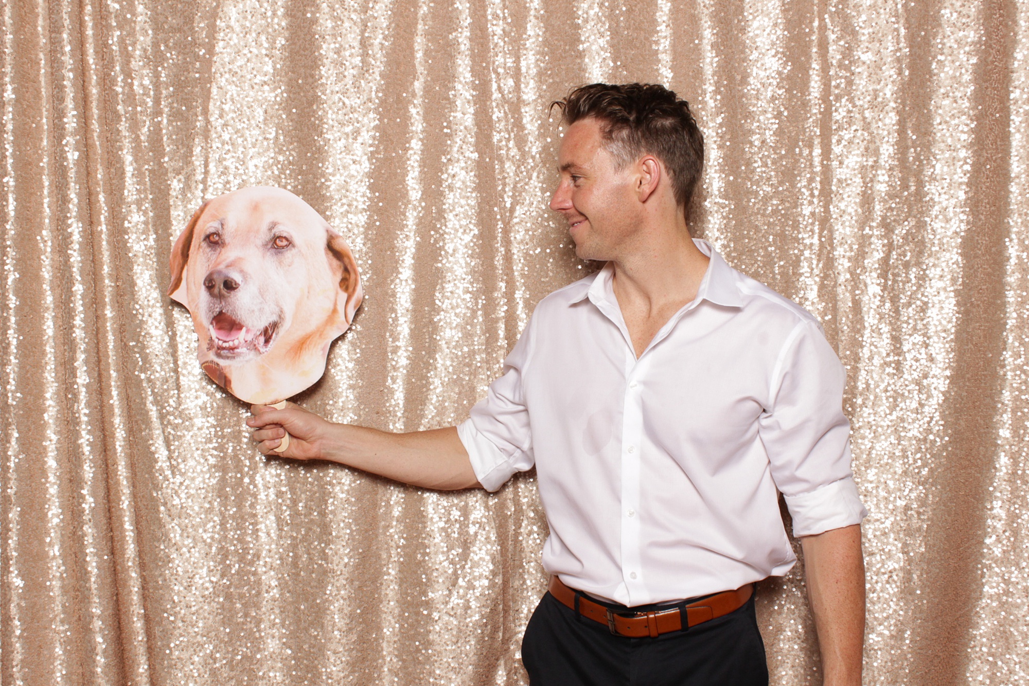 groomsman looks at cutout of dog during Sandy Hook Chapel Photo Booth