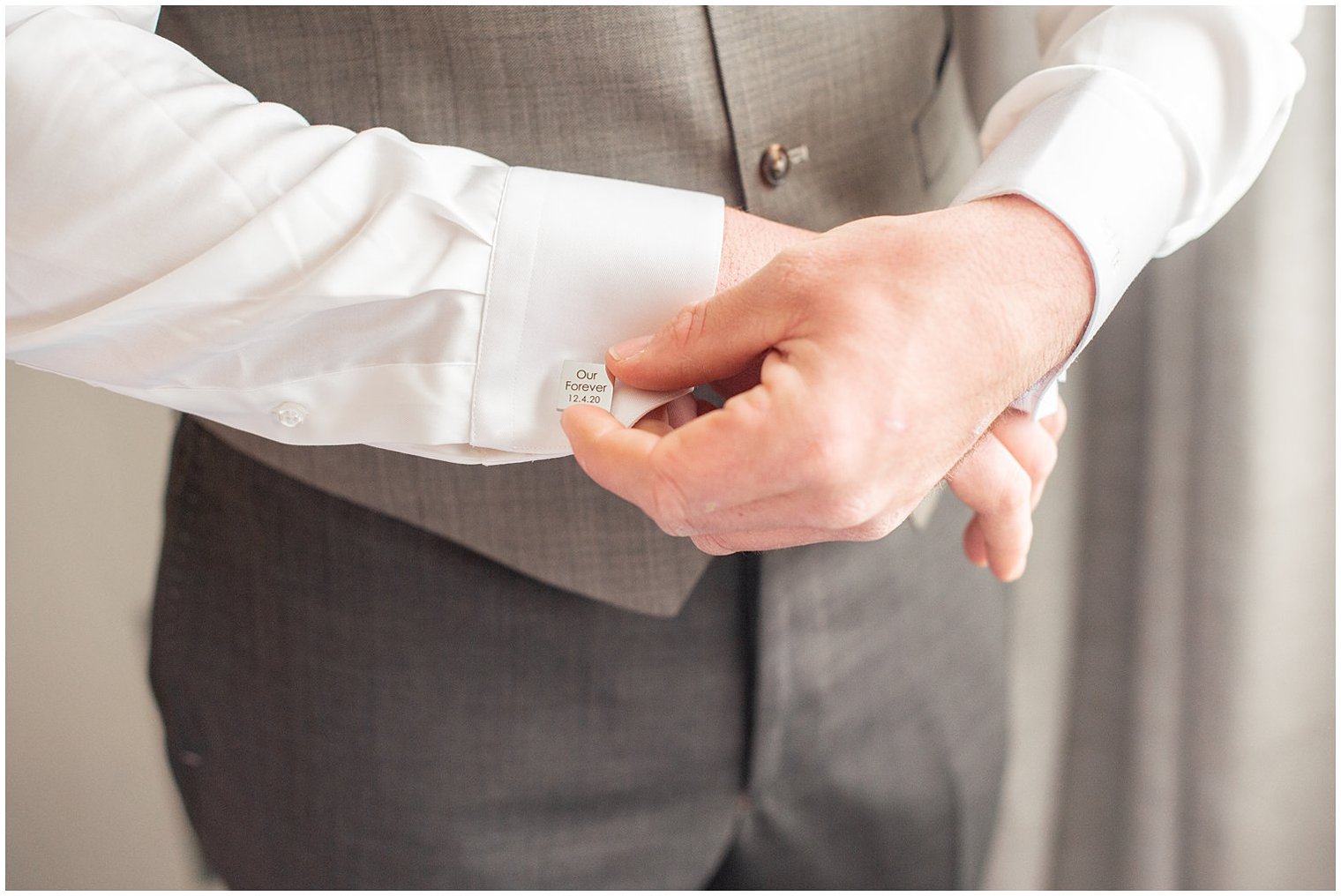 groom adjusts custom engraved cufflinks before NJ wedding