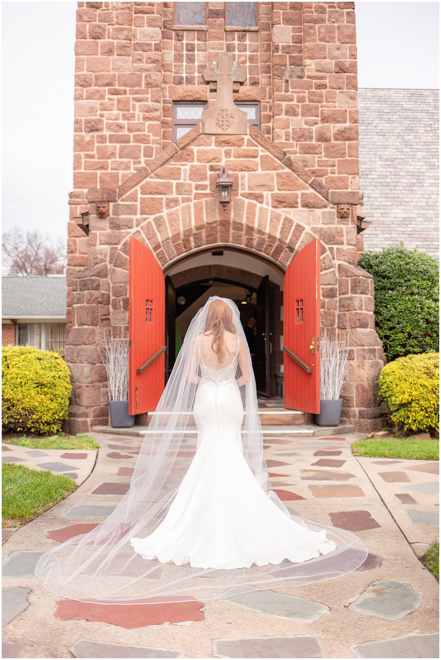 bride poses outside Grace Episcopal Church in Nutley