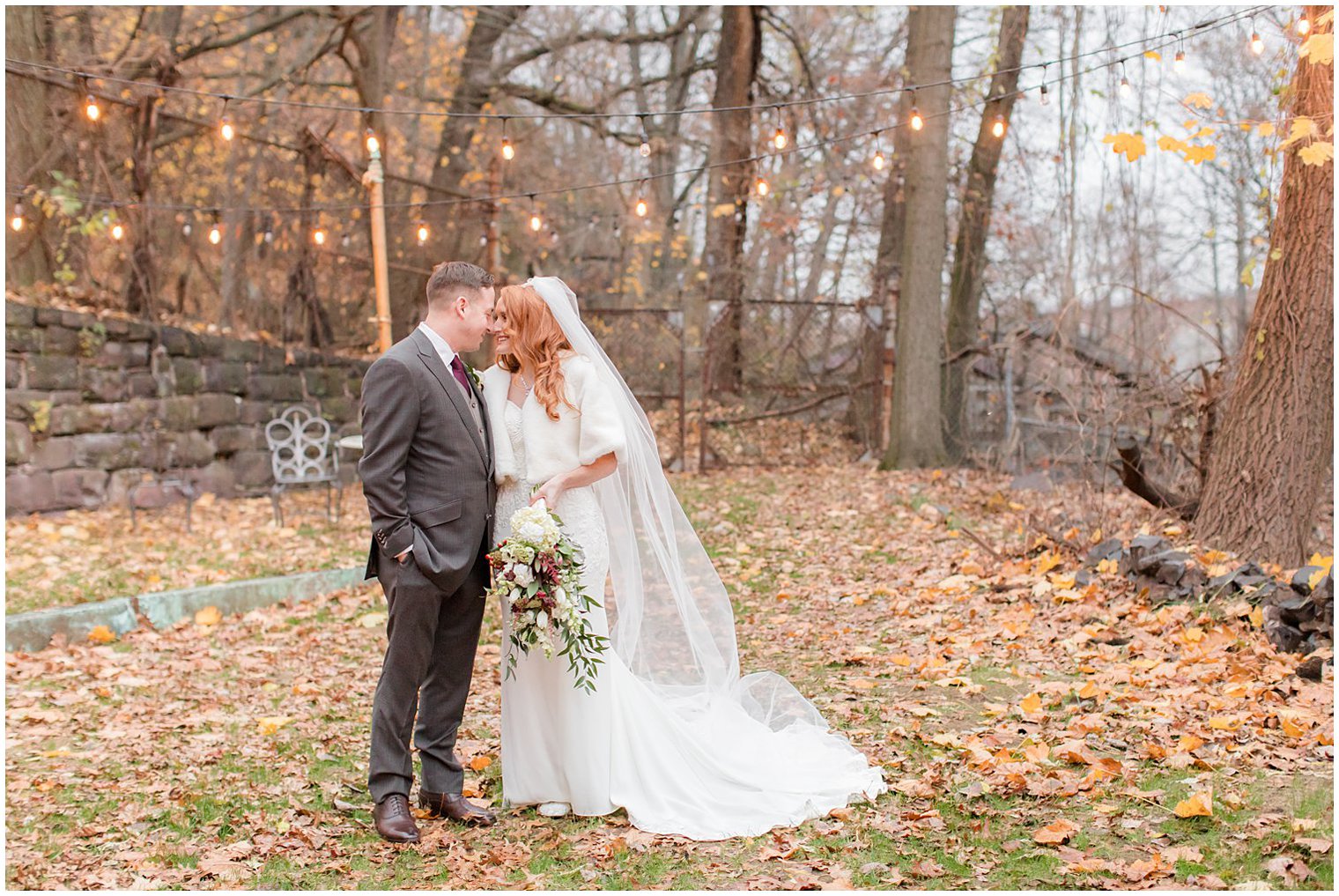 bride and groom pose under string lights at Art Factory Studios