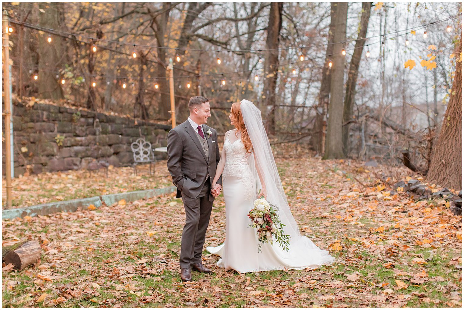 newlyweds pose on leaves in New Jersey photographed by Idalia Photography