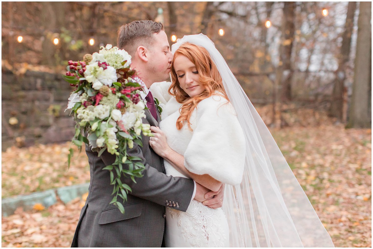 groom nuzzles bride's forehead during winter wedding portraits in New Jersey