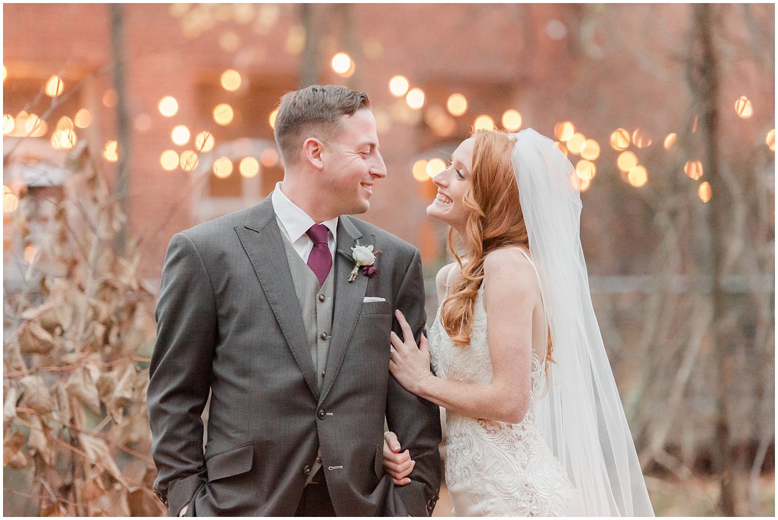 bride and groom smile at each other during winter wedding photos