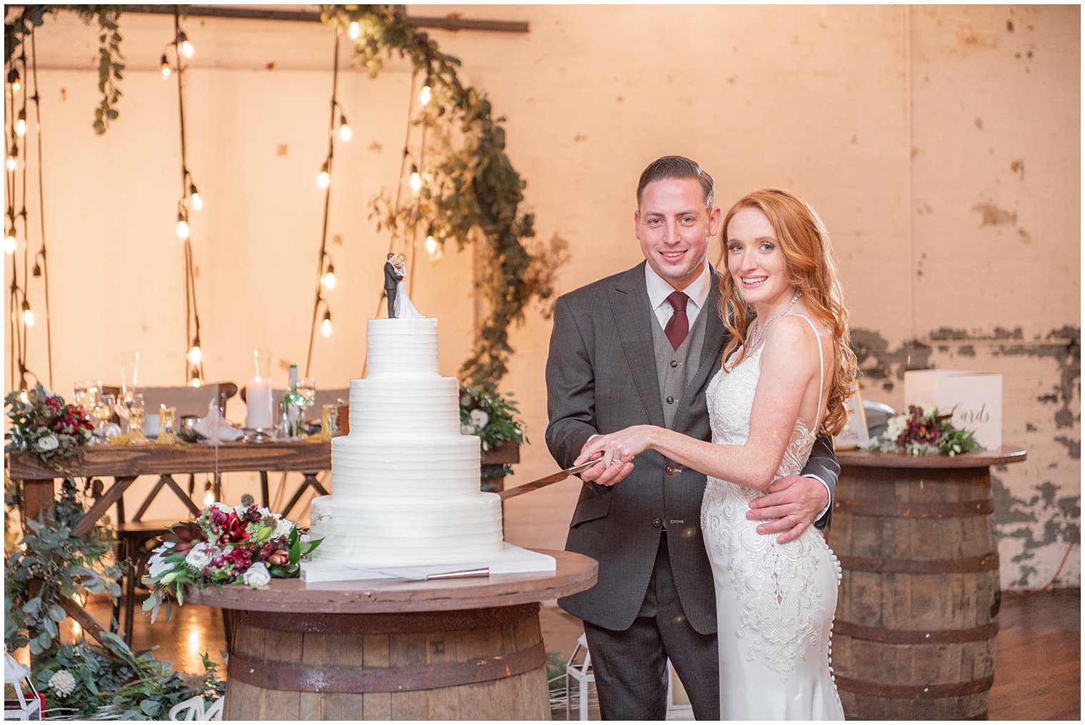 newlyweds cut wedding cake on wooden barrel in the Art Factory Studios 