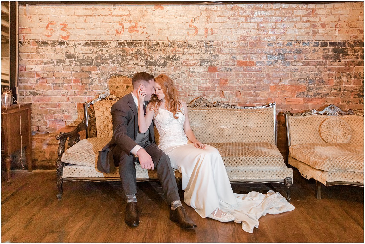 bride and groom pose on couch at Art Factory Studios wedding