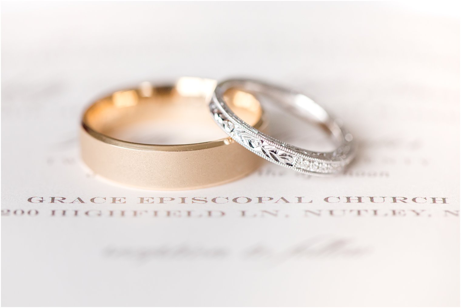 wedding bands rest on elegant winter wedding invitations from Minted