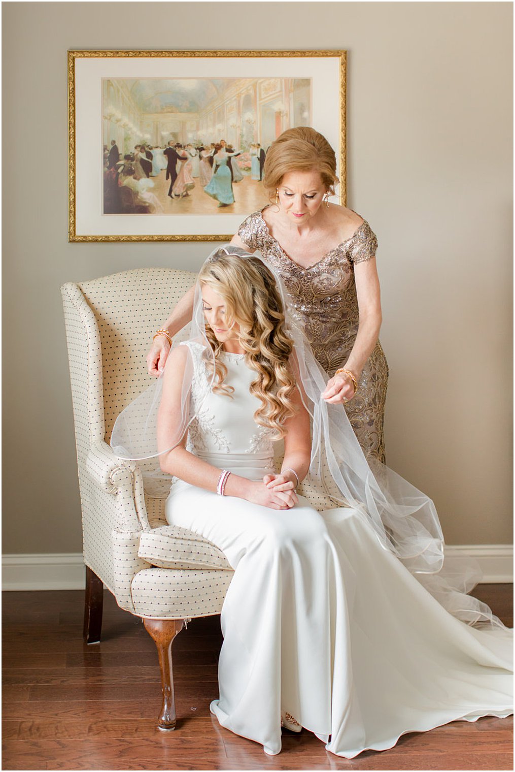 mother of the bride putting on her daughter's veil 