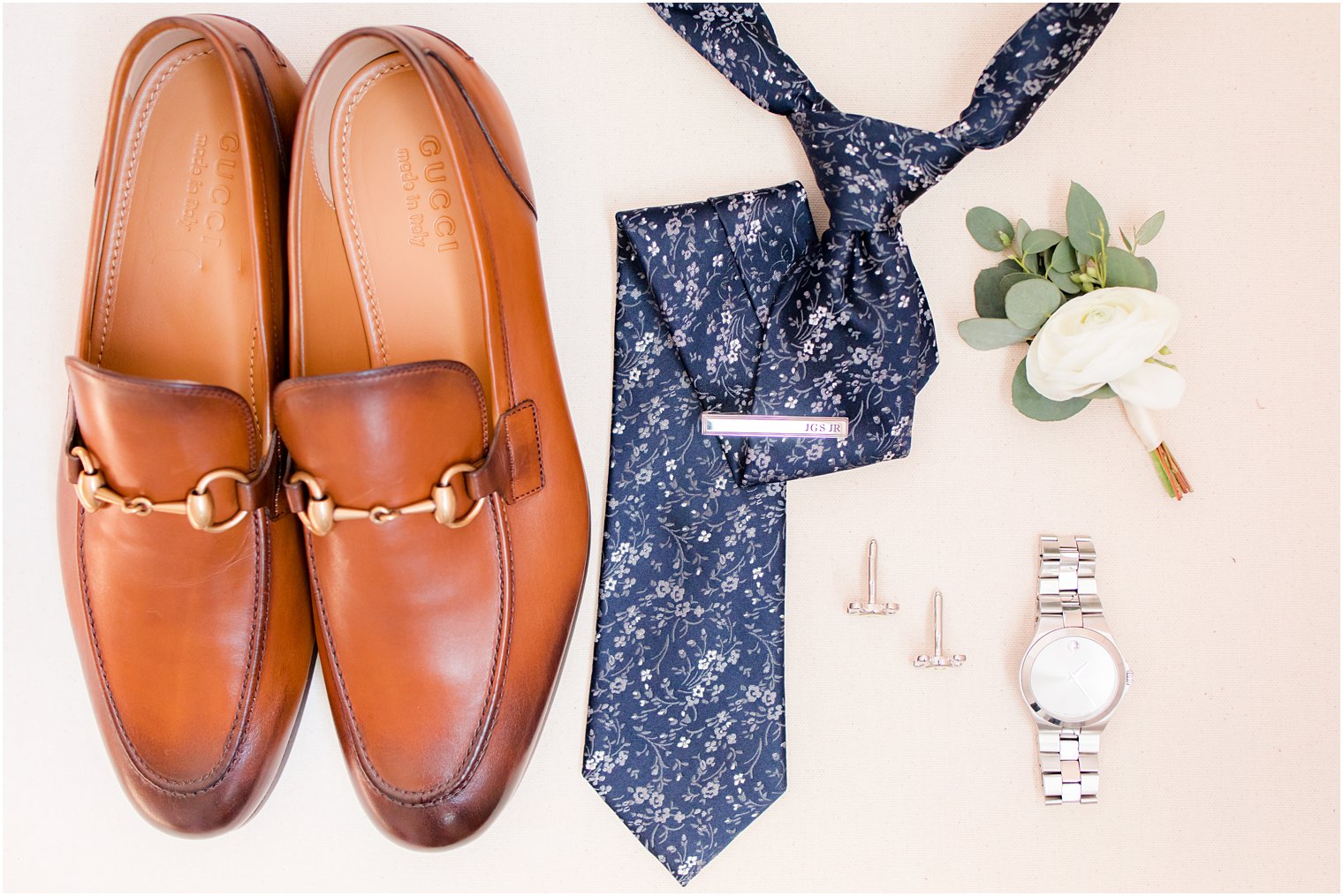 Groom wedding details with navy tie