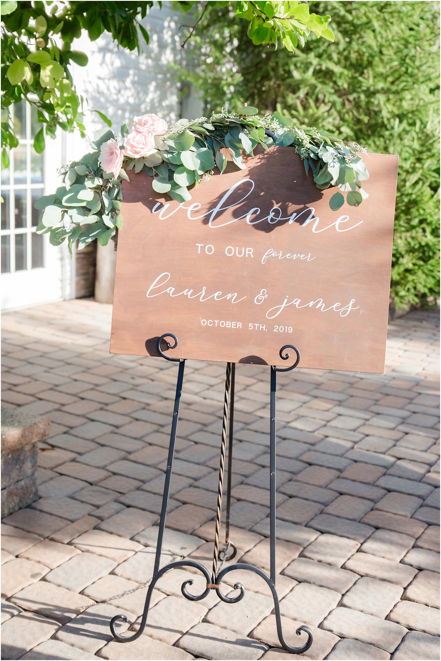 Wedding welcome sign in wood with greenery