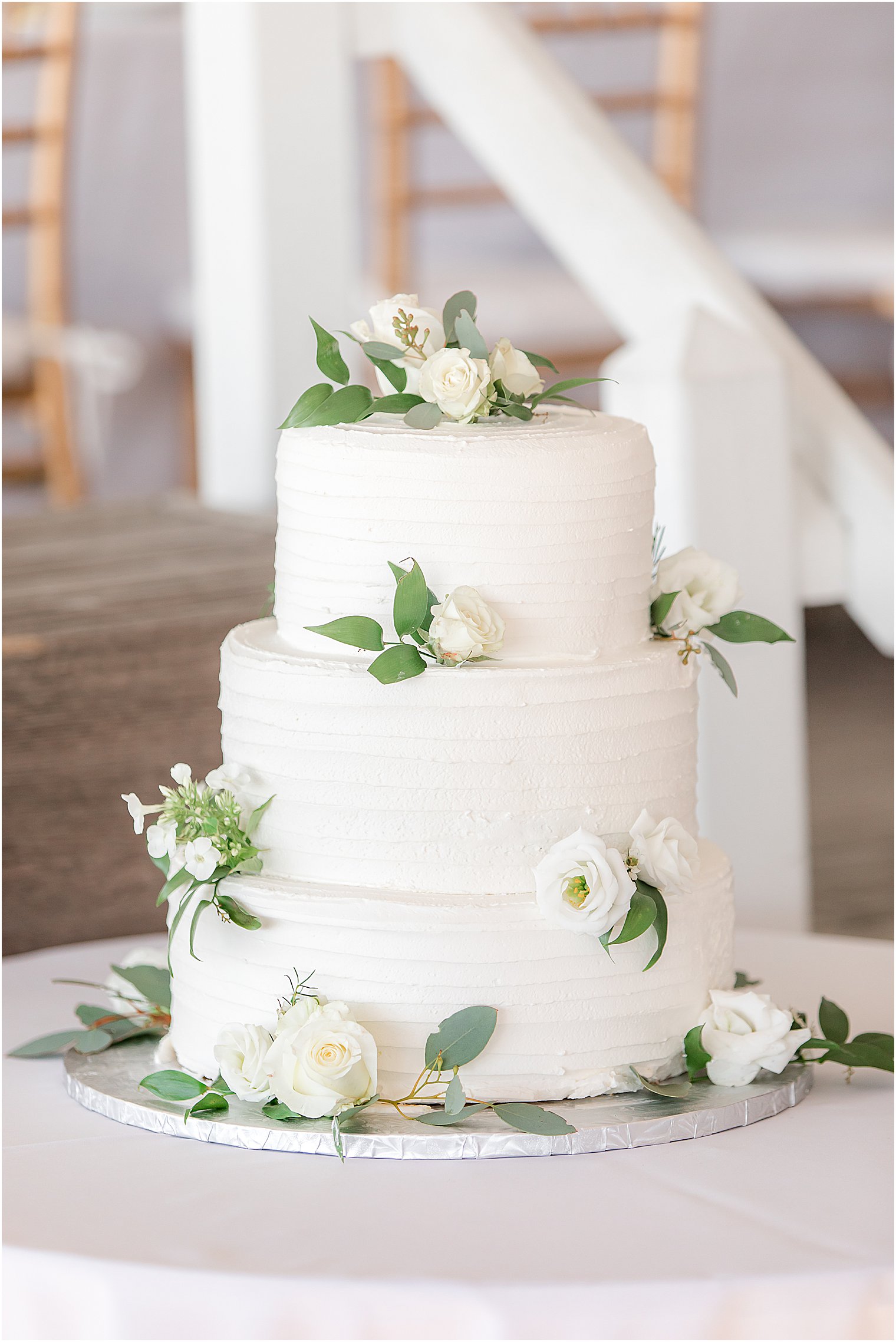 tiered wedding cake with simple flowers from Mueller's Bakery, one of the talented wedding cake designers in New Jersey