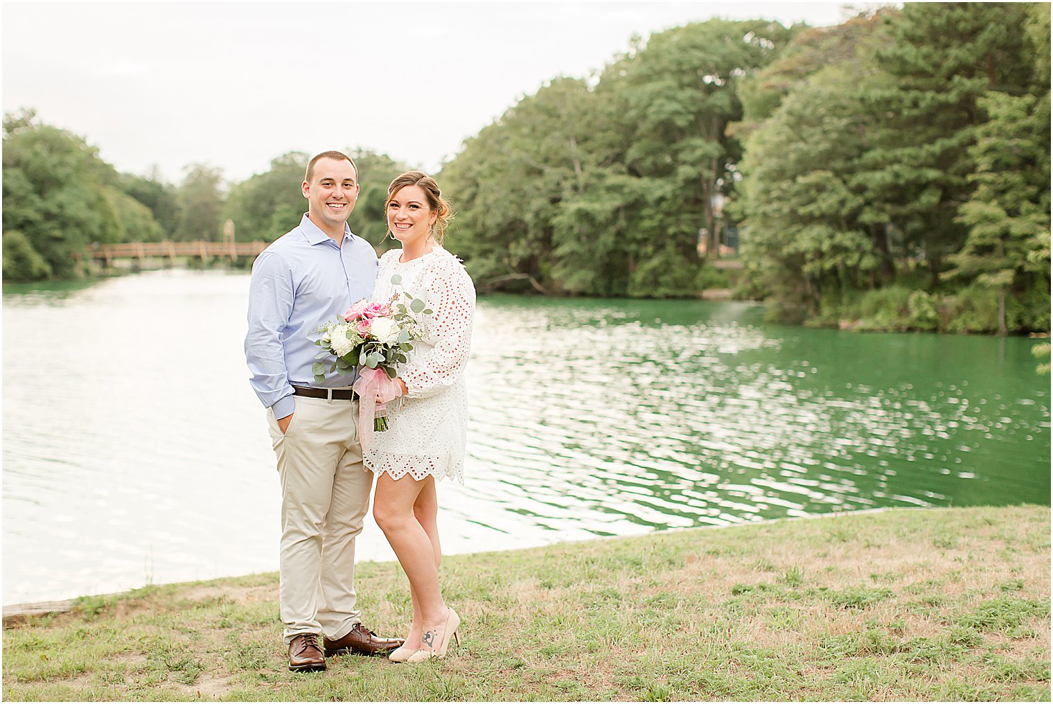 bride holds bouquet while posing with her fiance at Spring Lake NJ