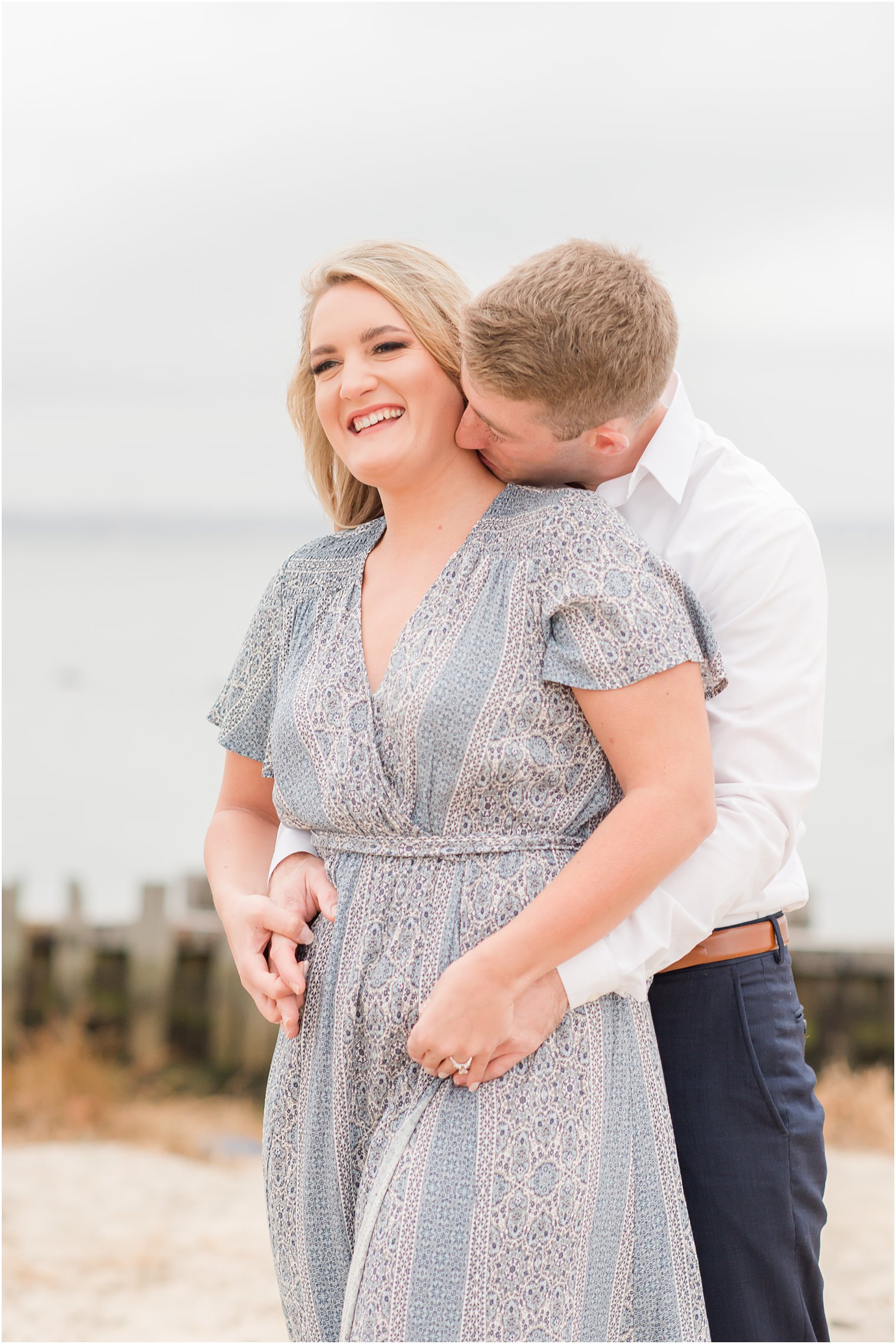 groom kisses bride's neck during New Jersey engagement photos