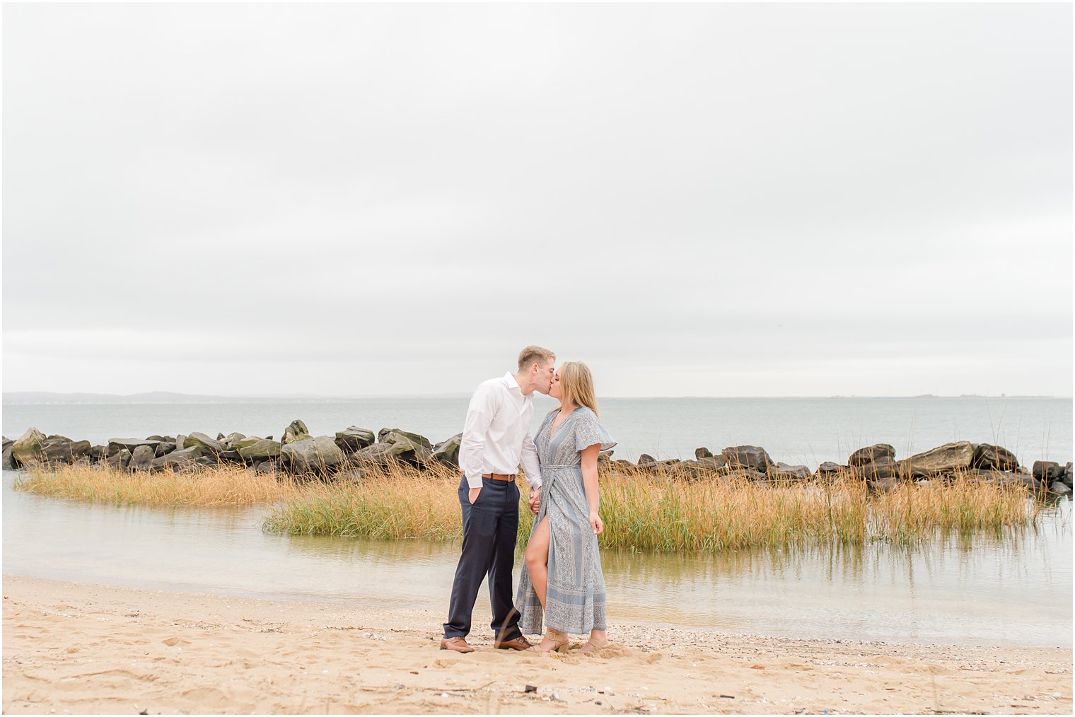 New Jersey couple poses in the sand at Sandy Hook Beach