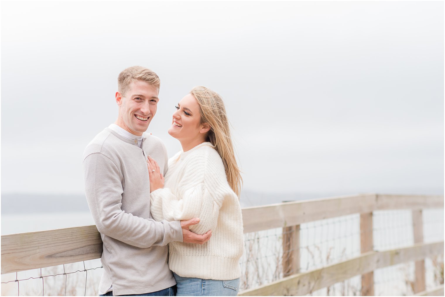 groom and bride laugh on bride at Sandy Hook Beach