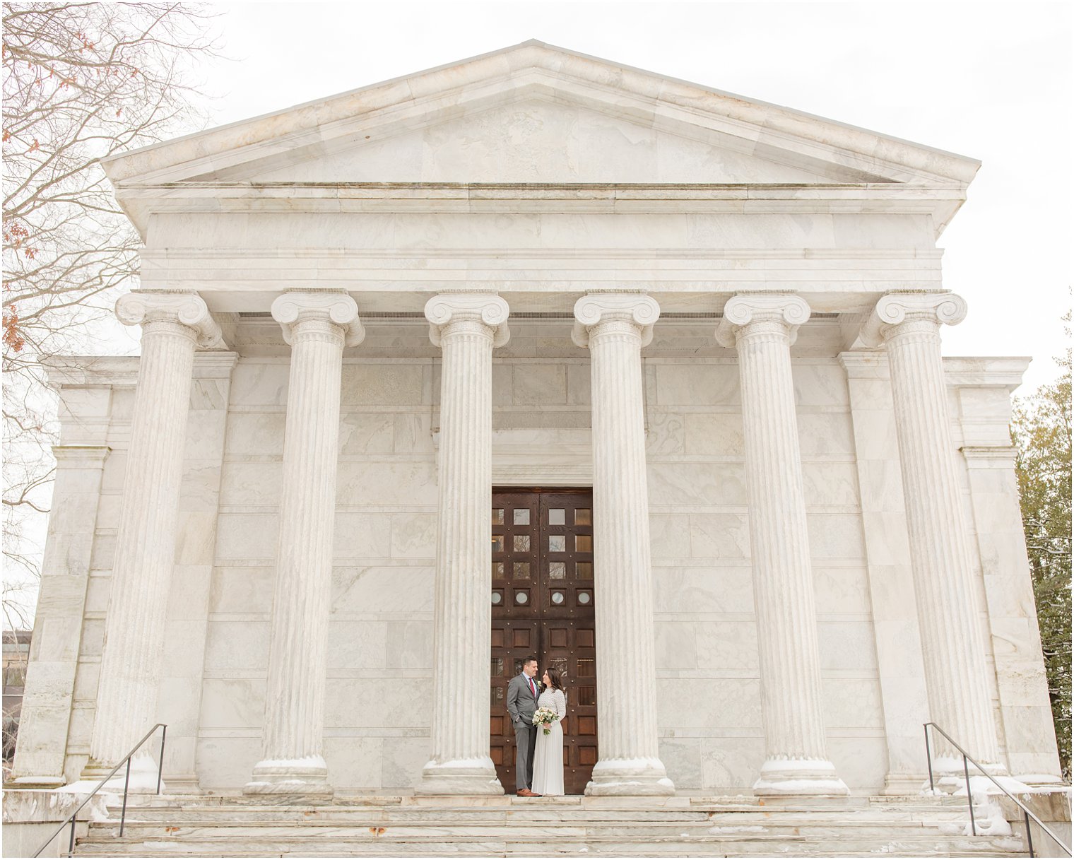 snowy wedding portraits on steps of Princeton University 