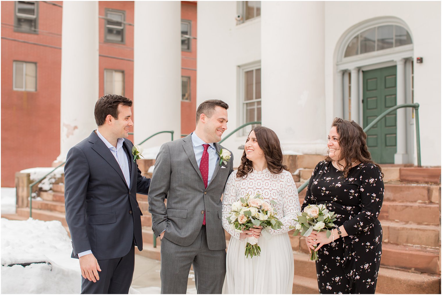 bride and groom pose with family members before NJ Courthouse wedding