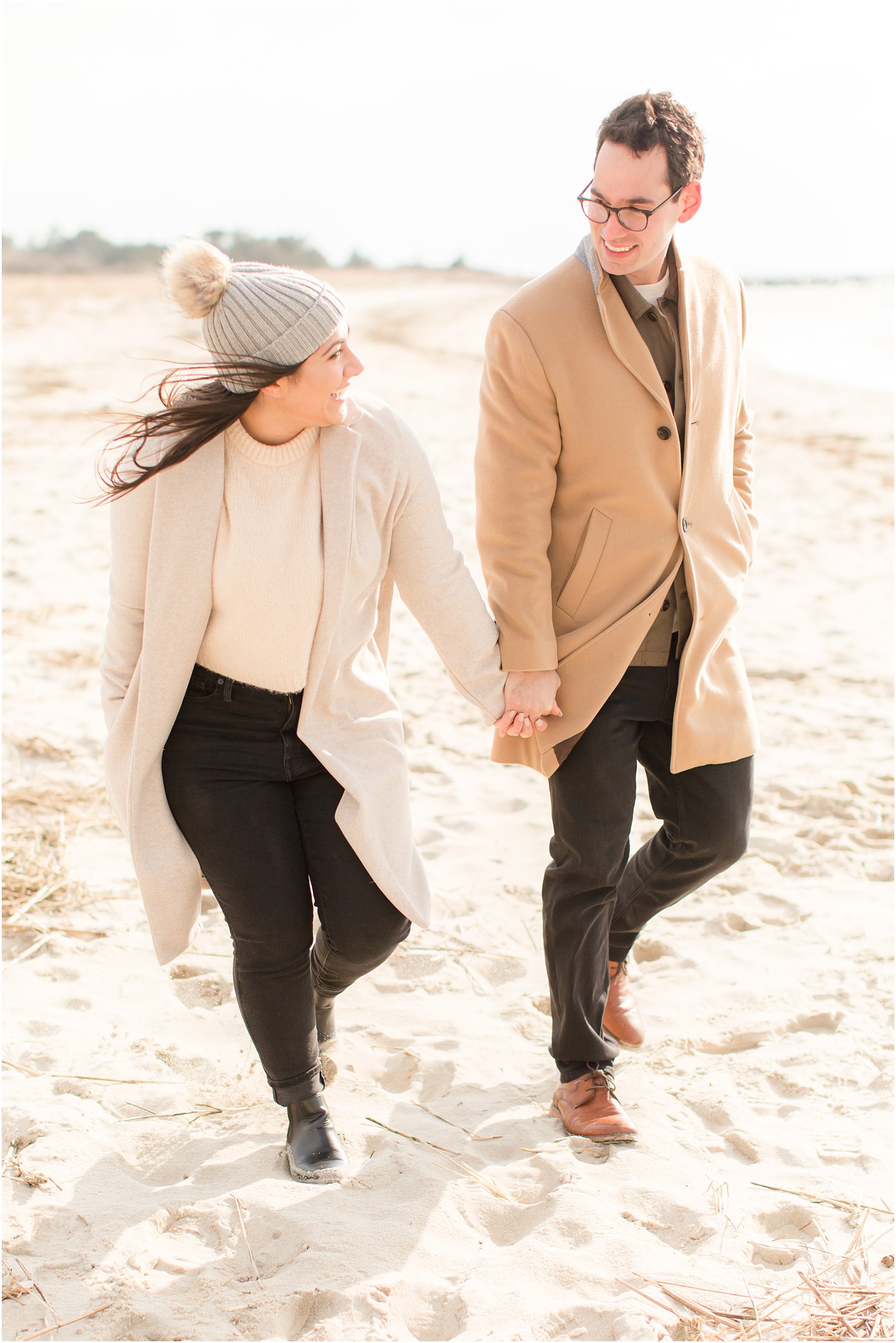Engaged couple walking on the beach in Cape May