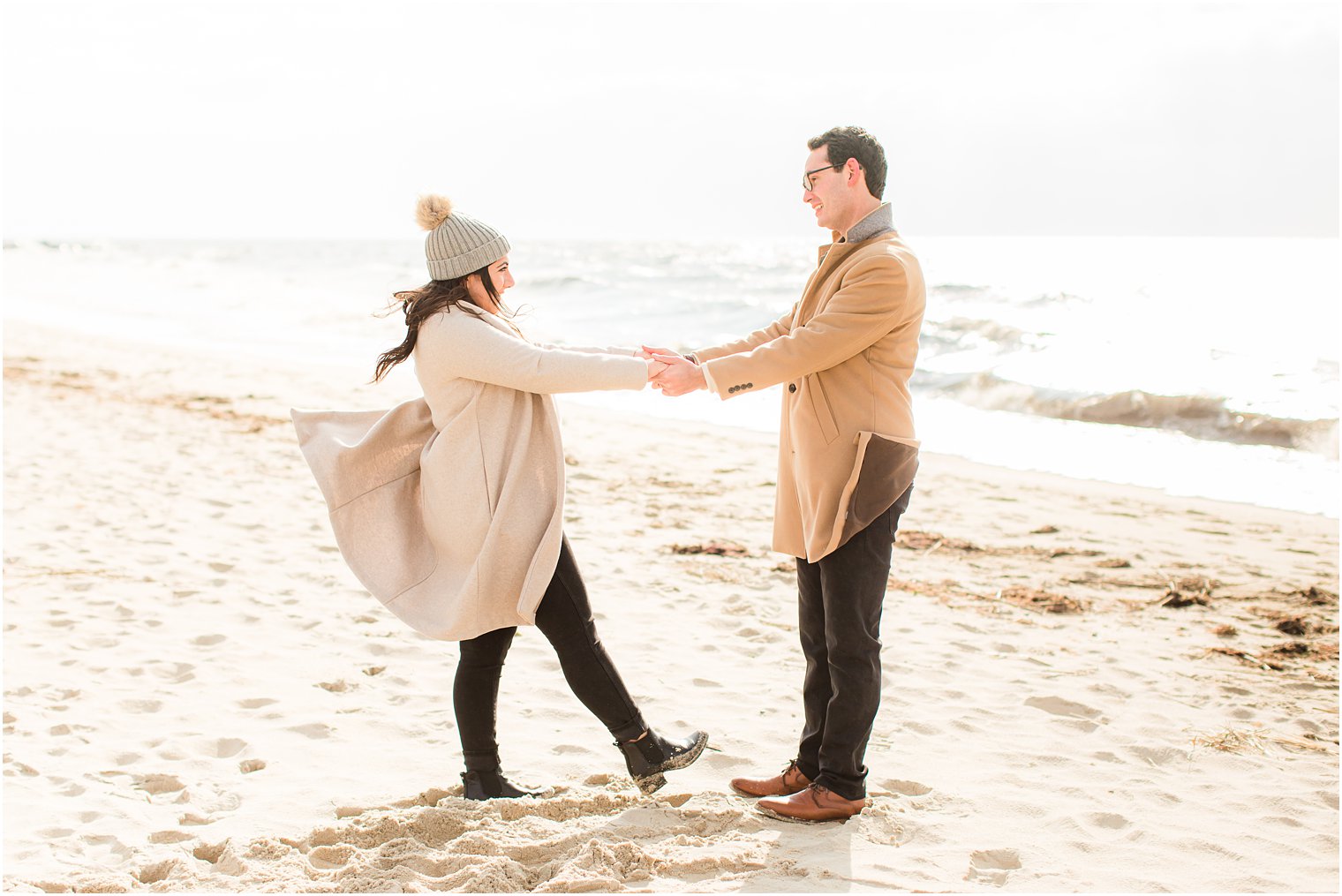Candid photo of couple at the beach during a winter session 