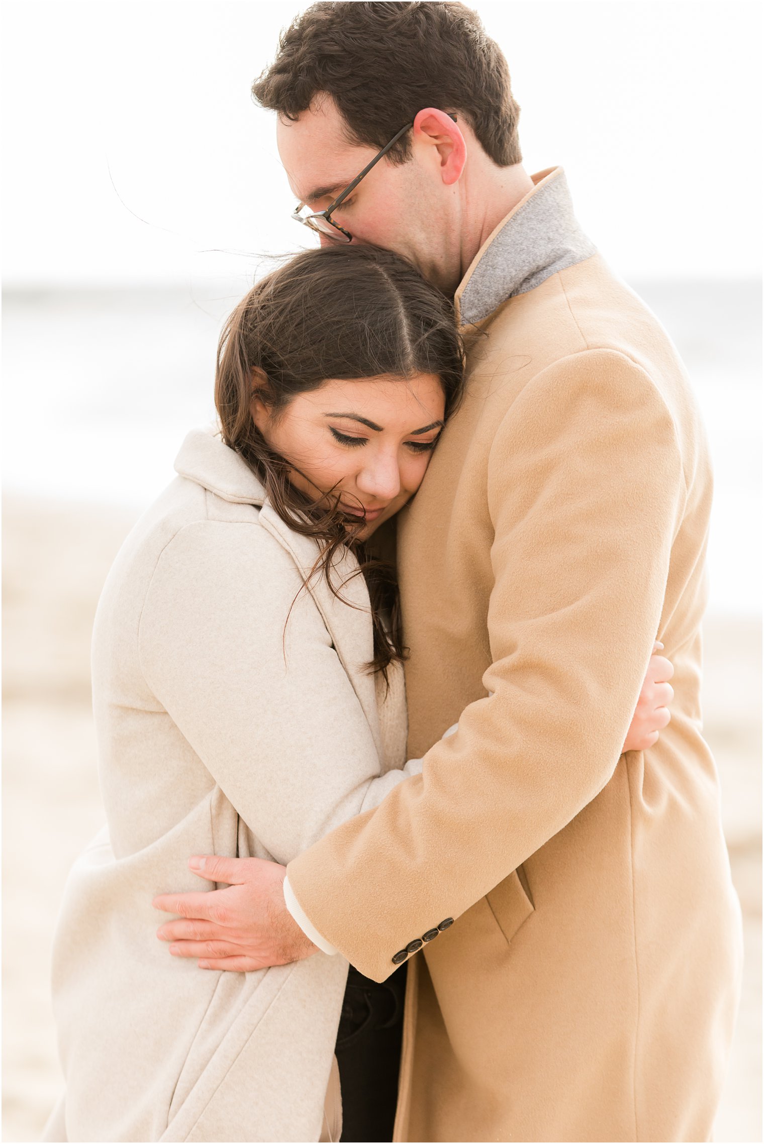 Engaged couple hugging during engagement photos