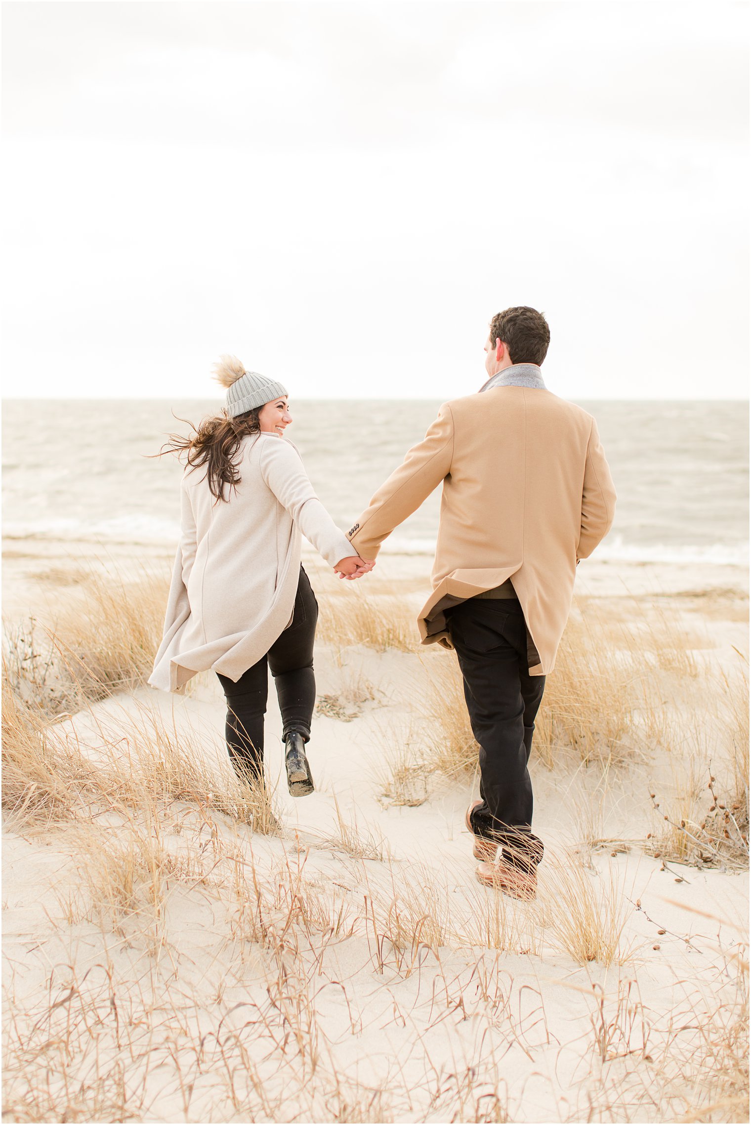 Couple walking away together on the beach in Cape May NJ