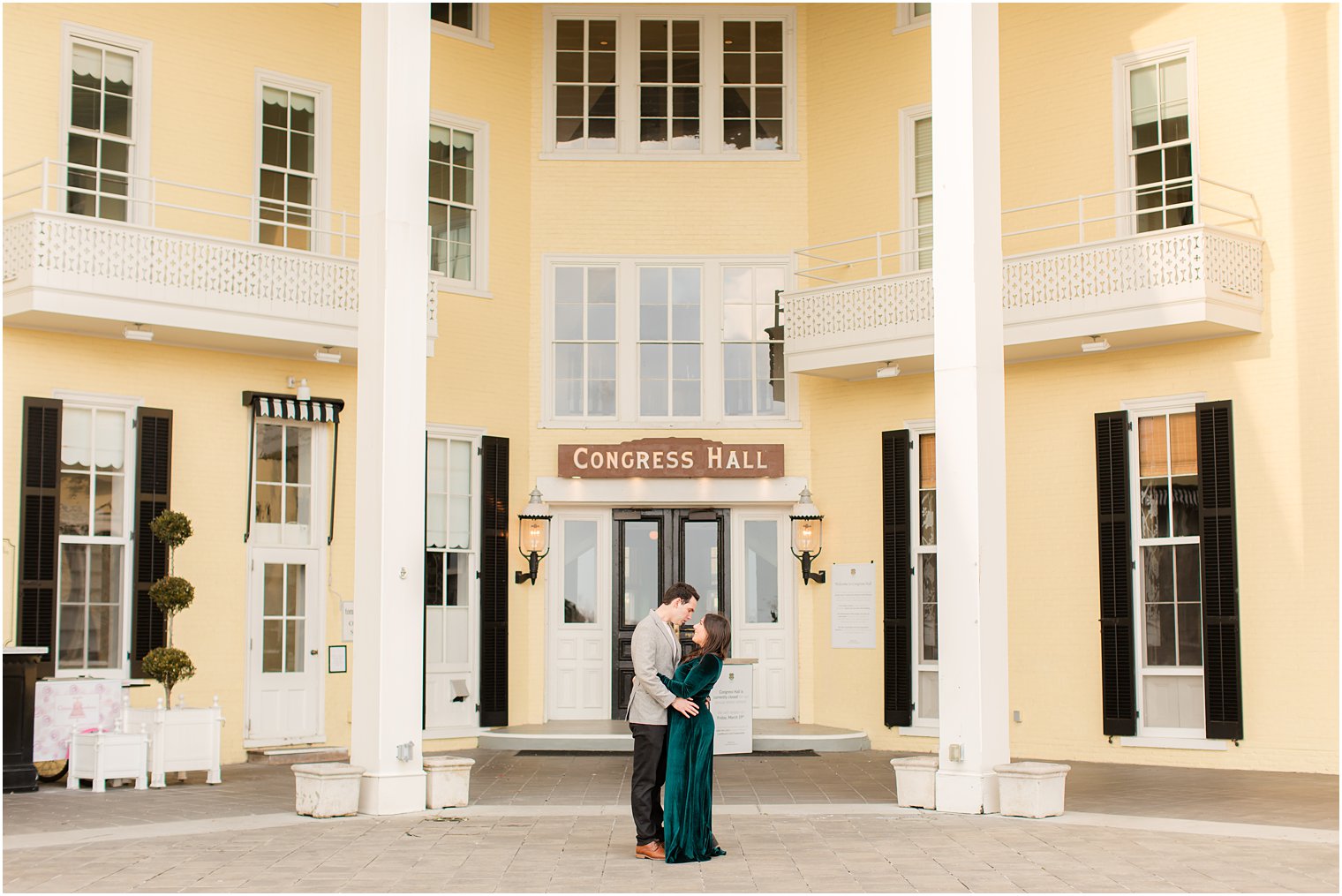 engaged couple standing in front of Congress Hall in Cape May, NJ