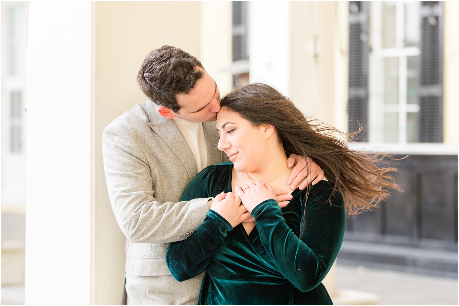 Couple embracing in front of Congress Hall in Cape May for their engagement photos