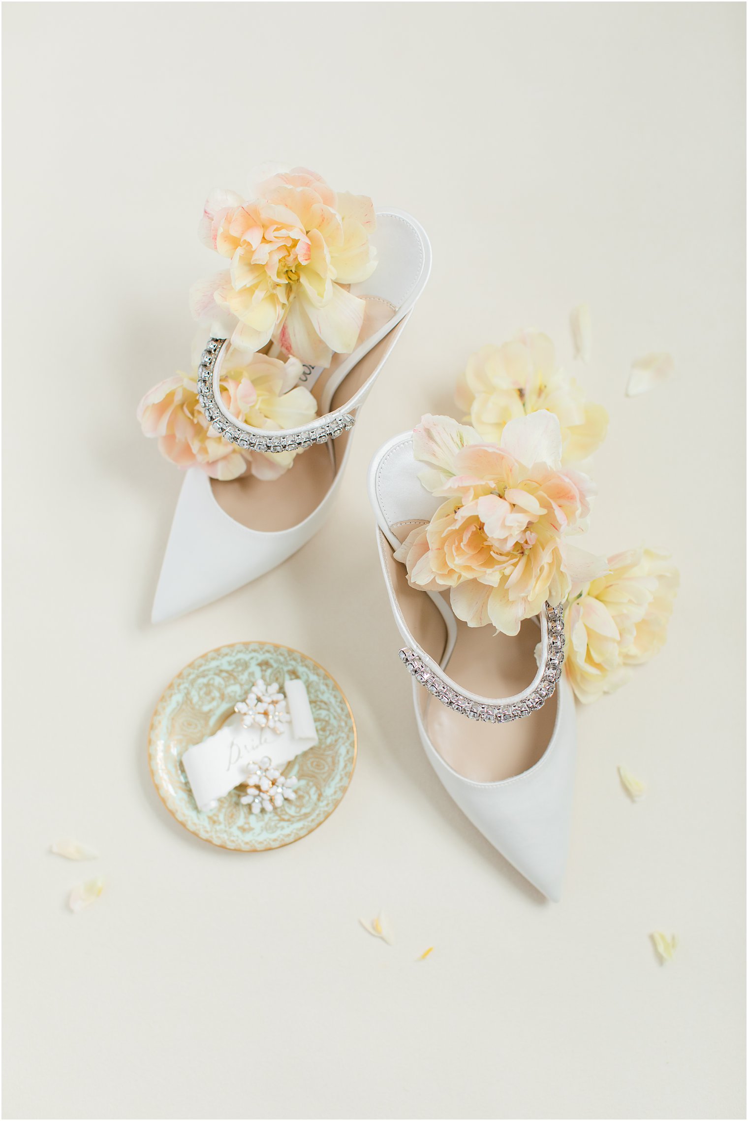 Shoes flatlay with white pumps and yellow florals