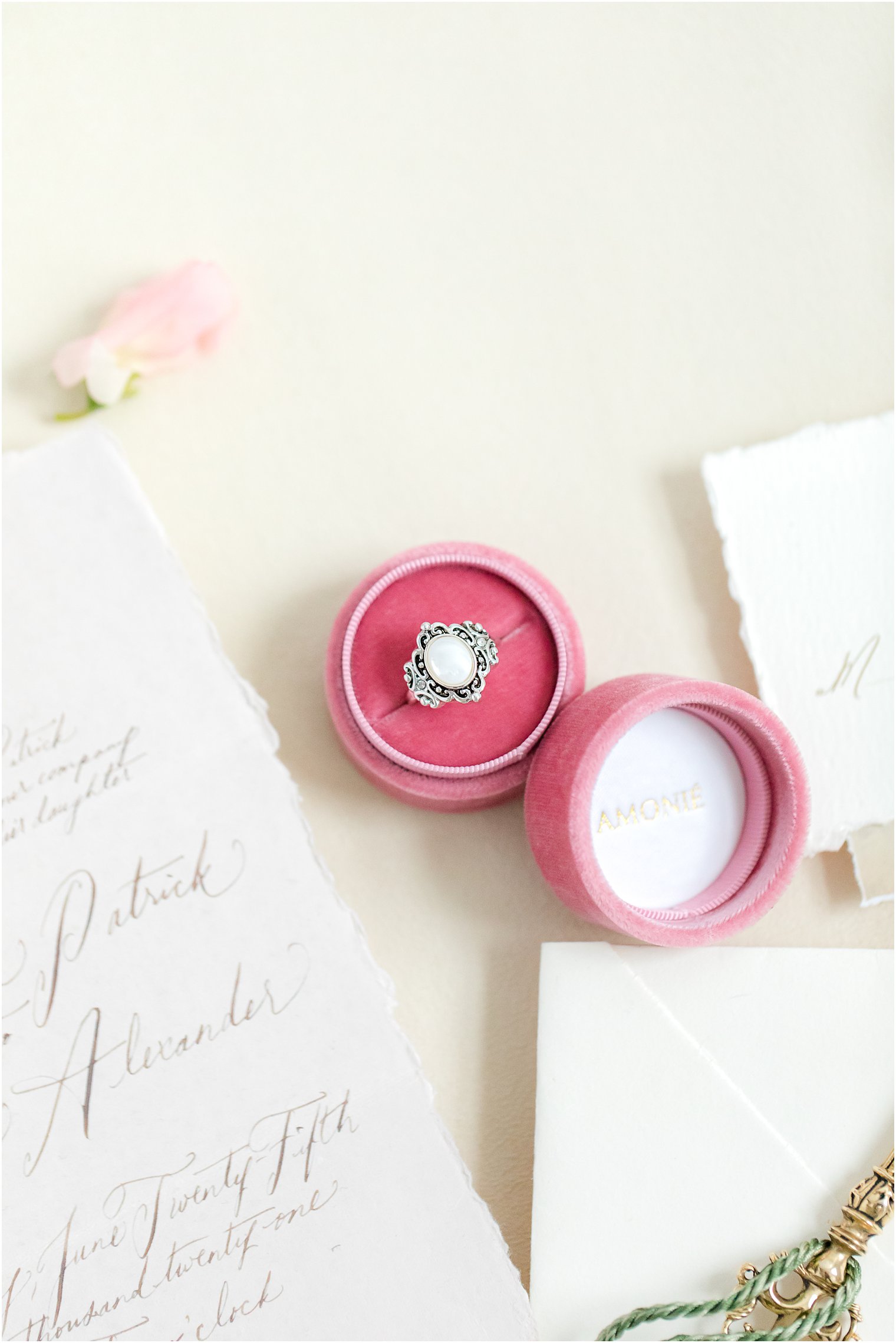 White stone engagement ring in pink ring box by Amonie