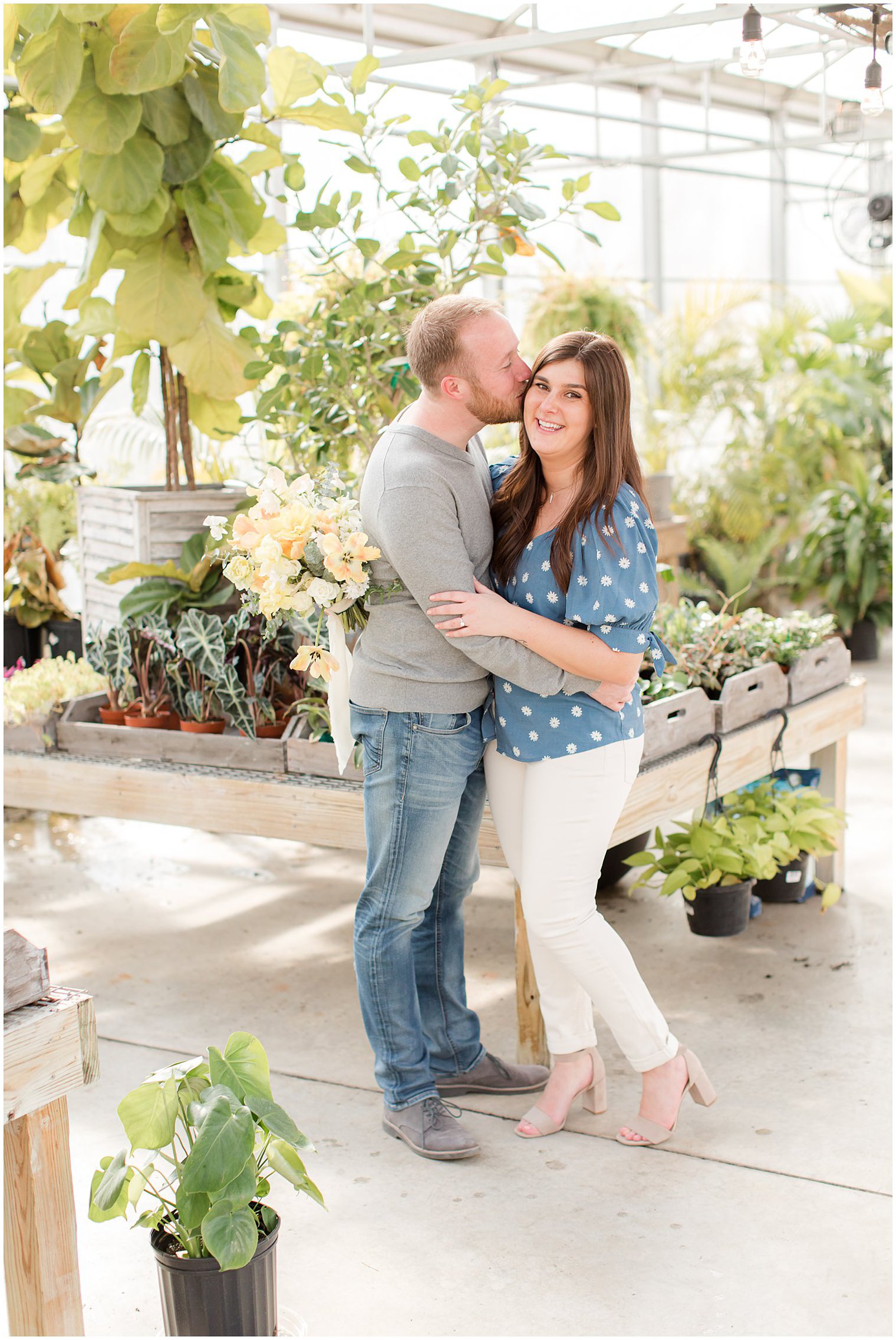 groom kisses bride's forehead during NJ engagement photos at Herbary at Bear Creek