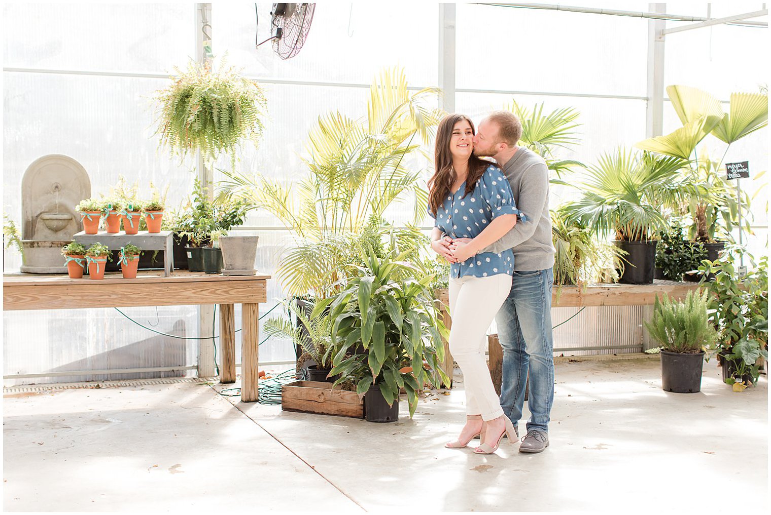 groom kisses bride's cheek during greenhouse at Herbary at Bear Creek