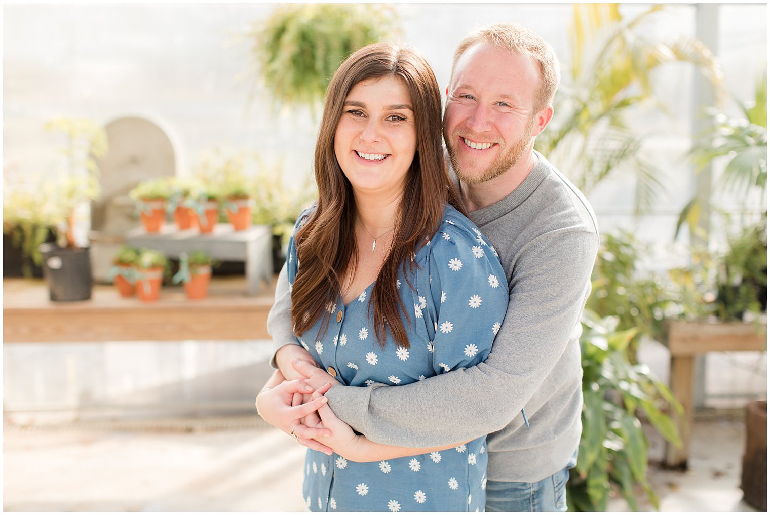 bride and groom hug in greenhouse at Herbary at Bear Creek