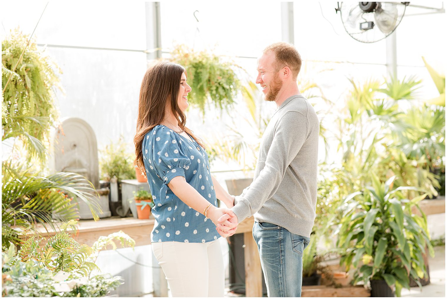 engaged couple holds hands in NJ greenhouse at Herbary at Bear Creek