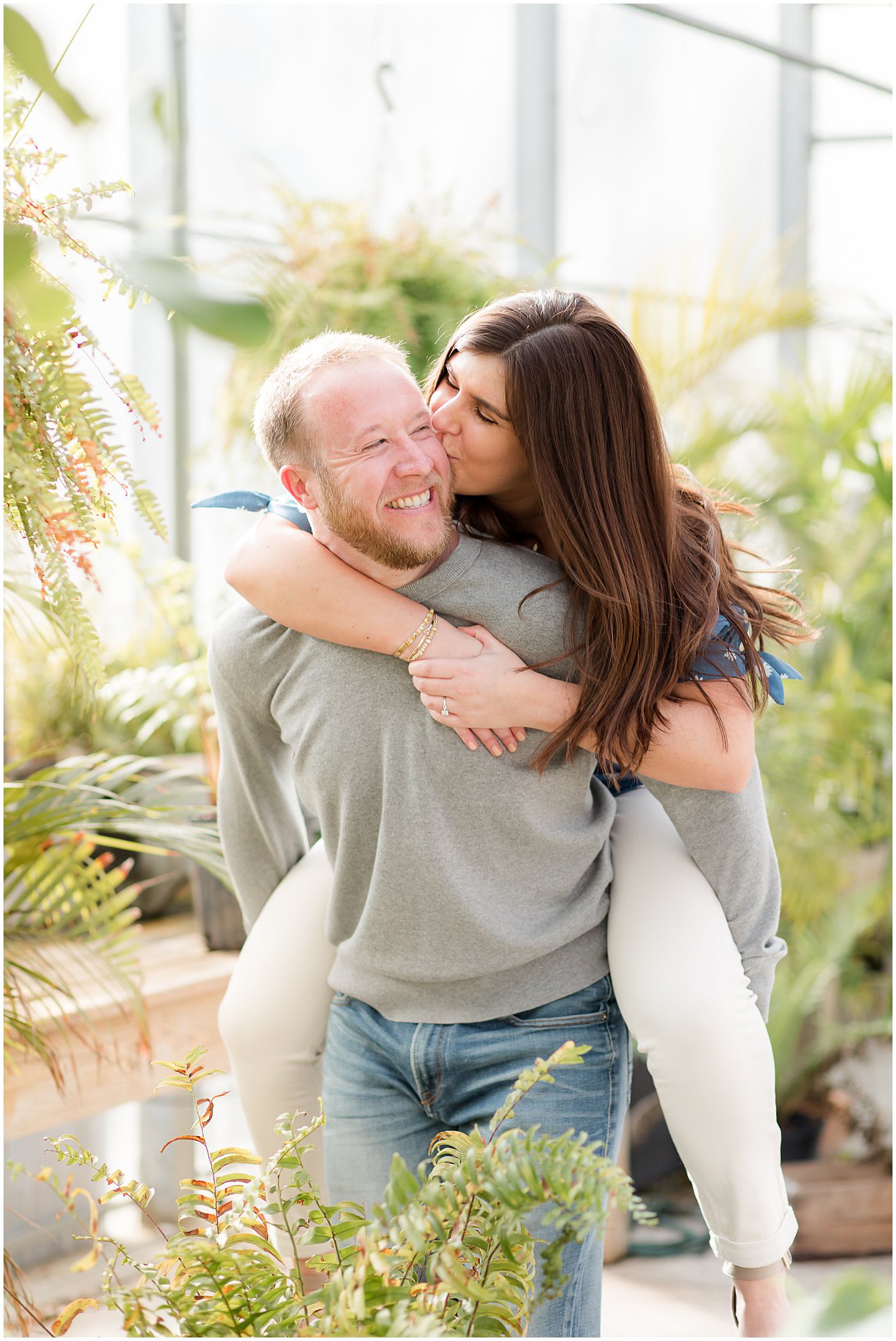 bride kisses groom's cheek during piggy back ride at Herbary at Bear Creek