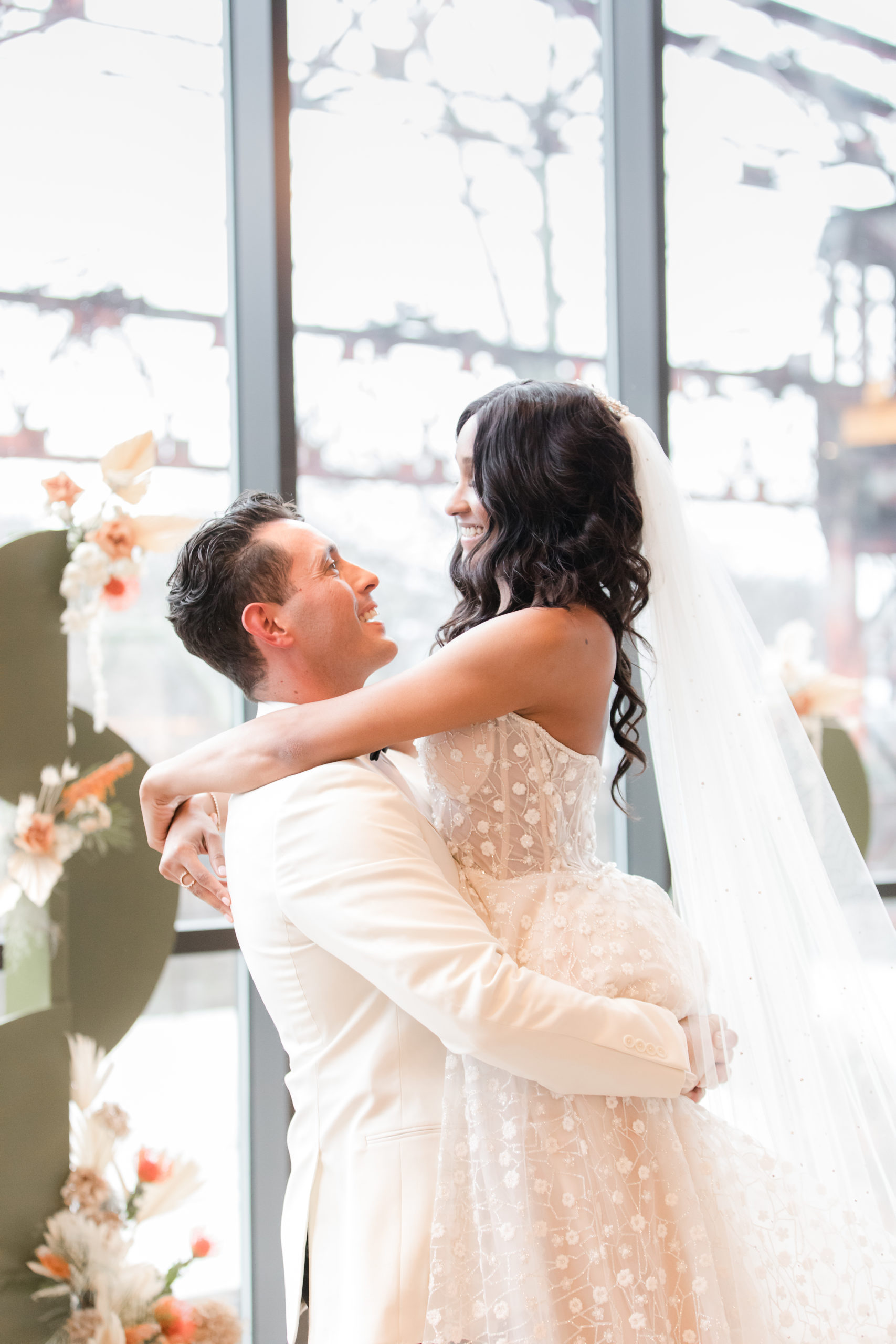 groom lifts bride during Philadelphia wedding photos in Ironworks at Pencoyd Landing