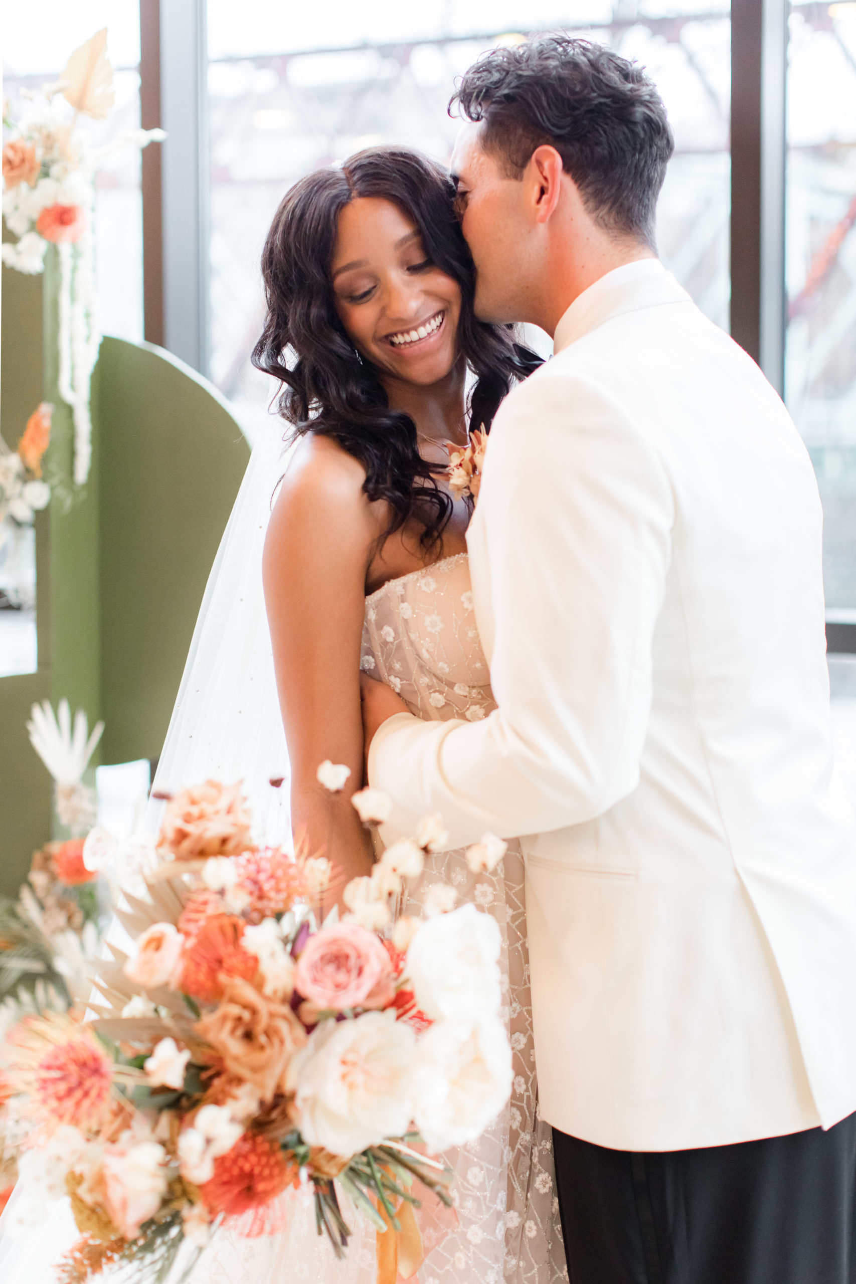 groom nuzzles bride's ear during wedding photos in Philadelphia PA