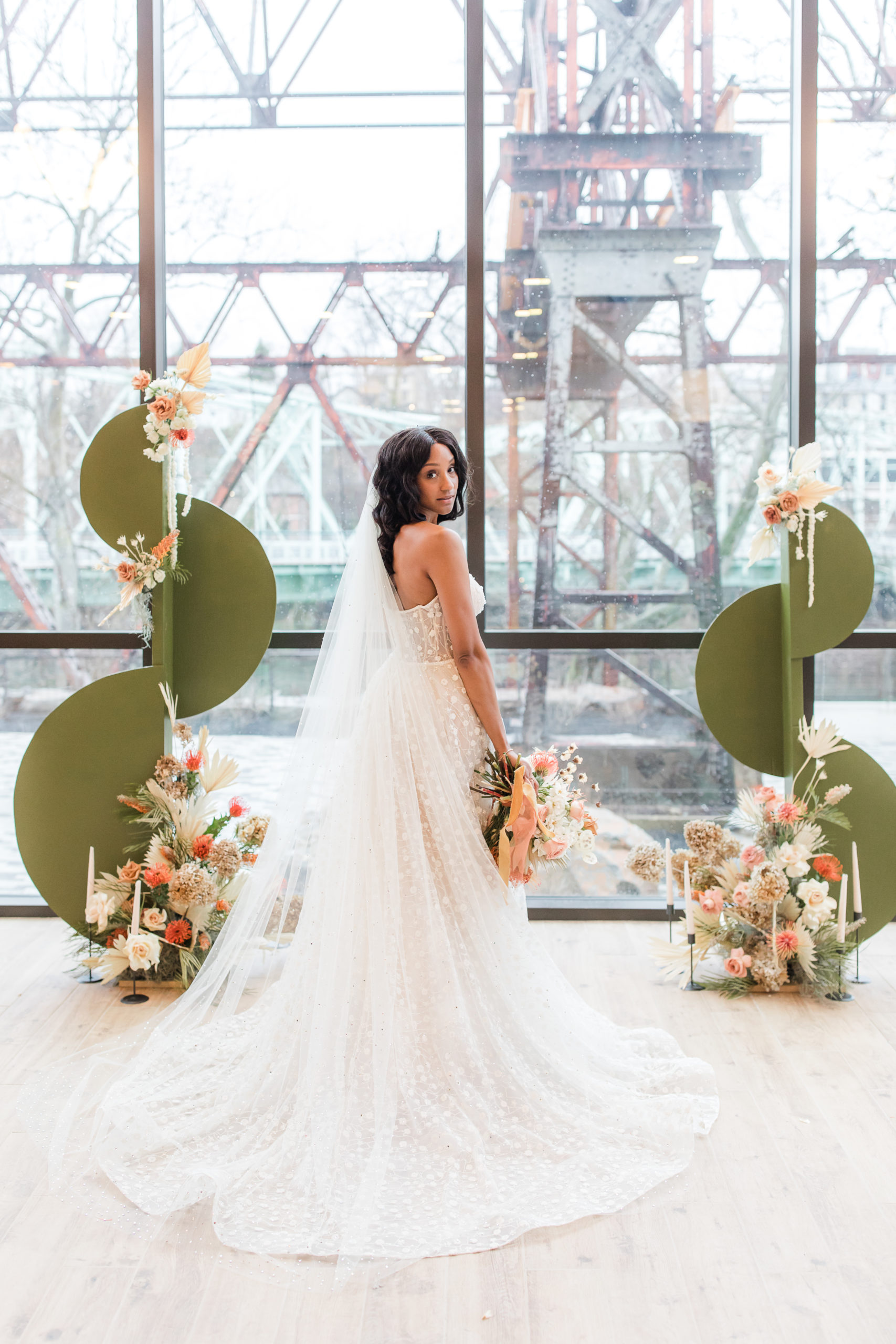 modern bridal portrait in front of windows overlooking Philadelphia PA