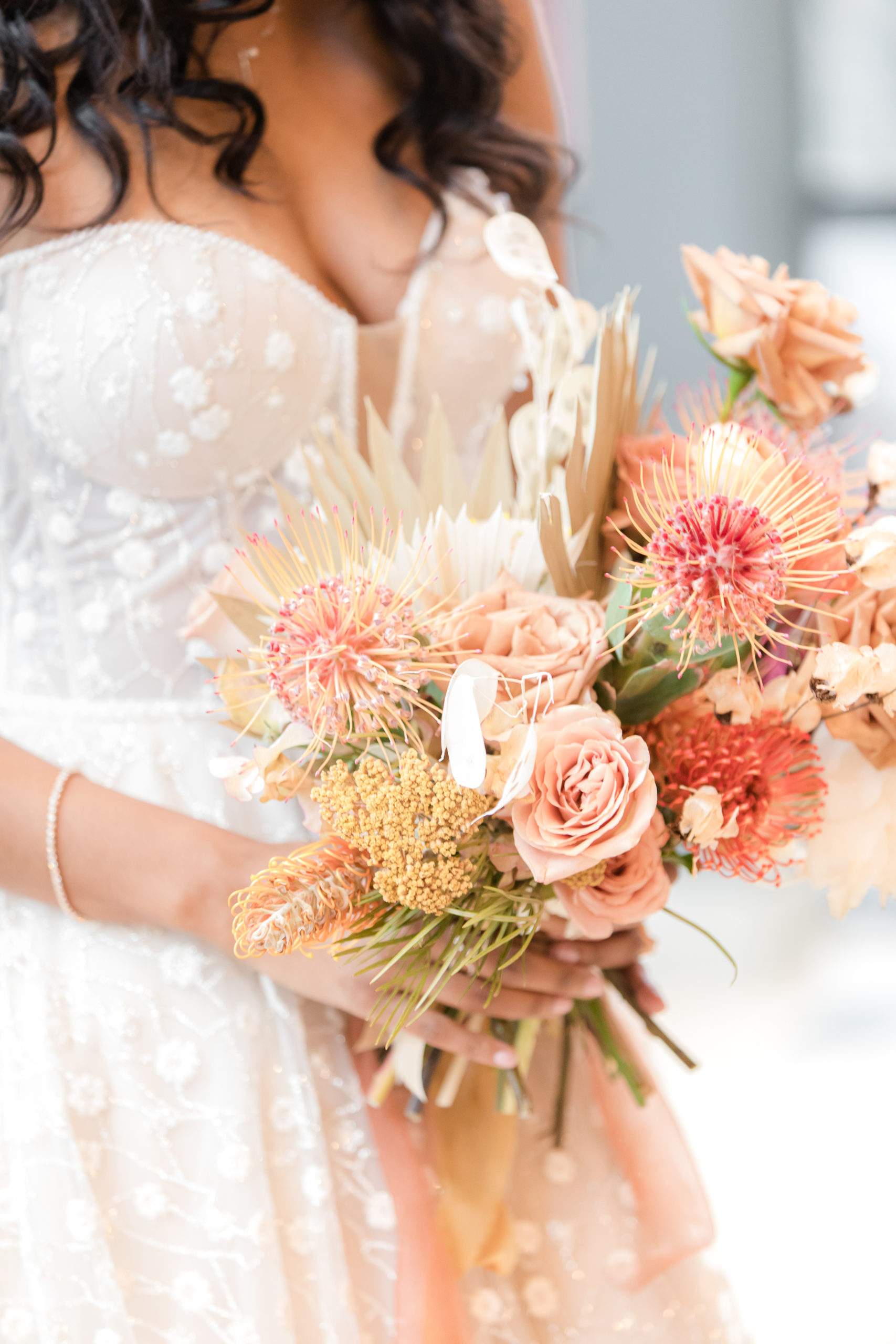 bride holds bouquet of unique pink flowers during Shootout Society Styled Shoot 