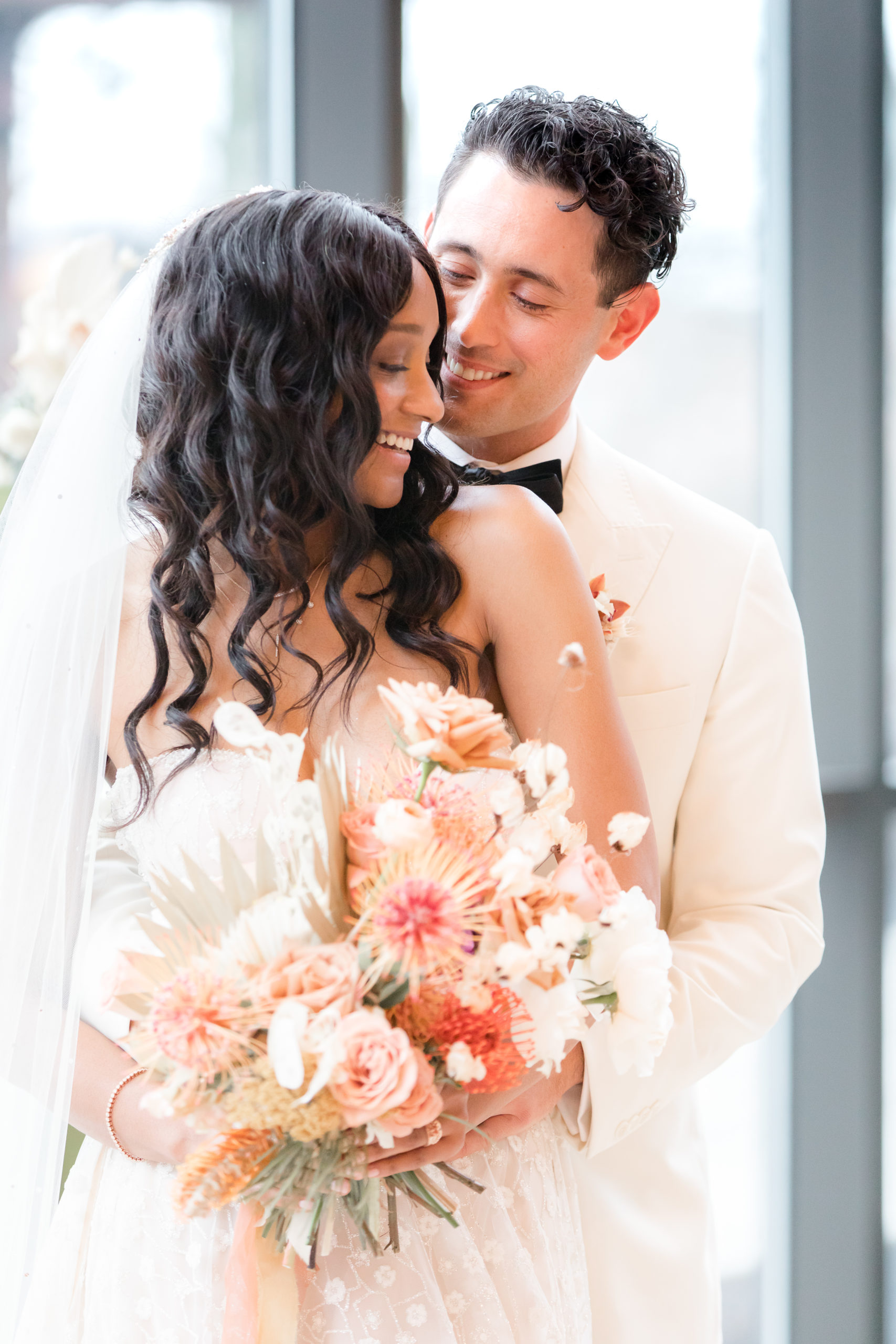 bride and groom hug laughing during styled shoot portraits at Ironworks at Pencoyd Landing